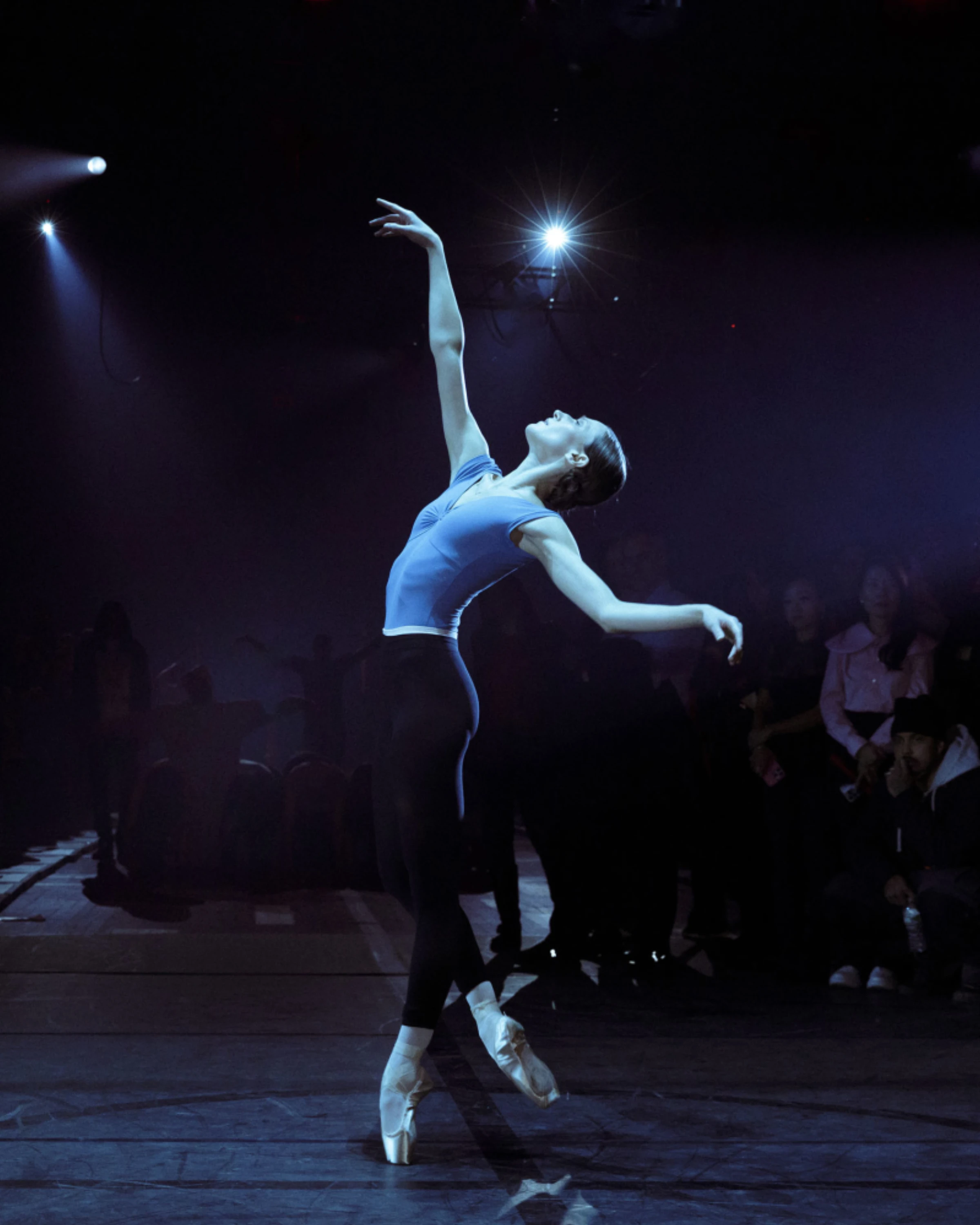 Anne Imhof installation view featuring a dark architectural environment and performers.