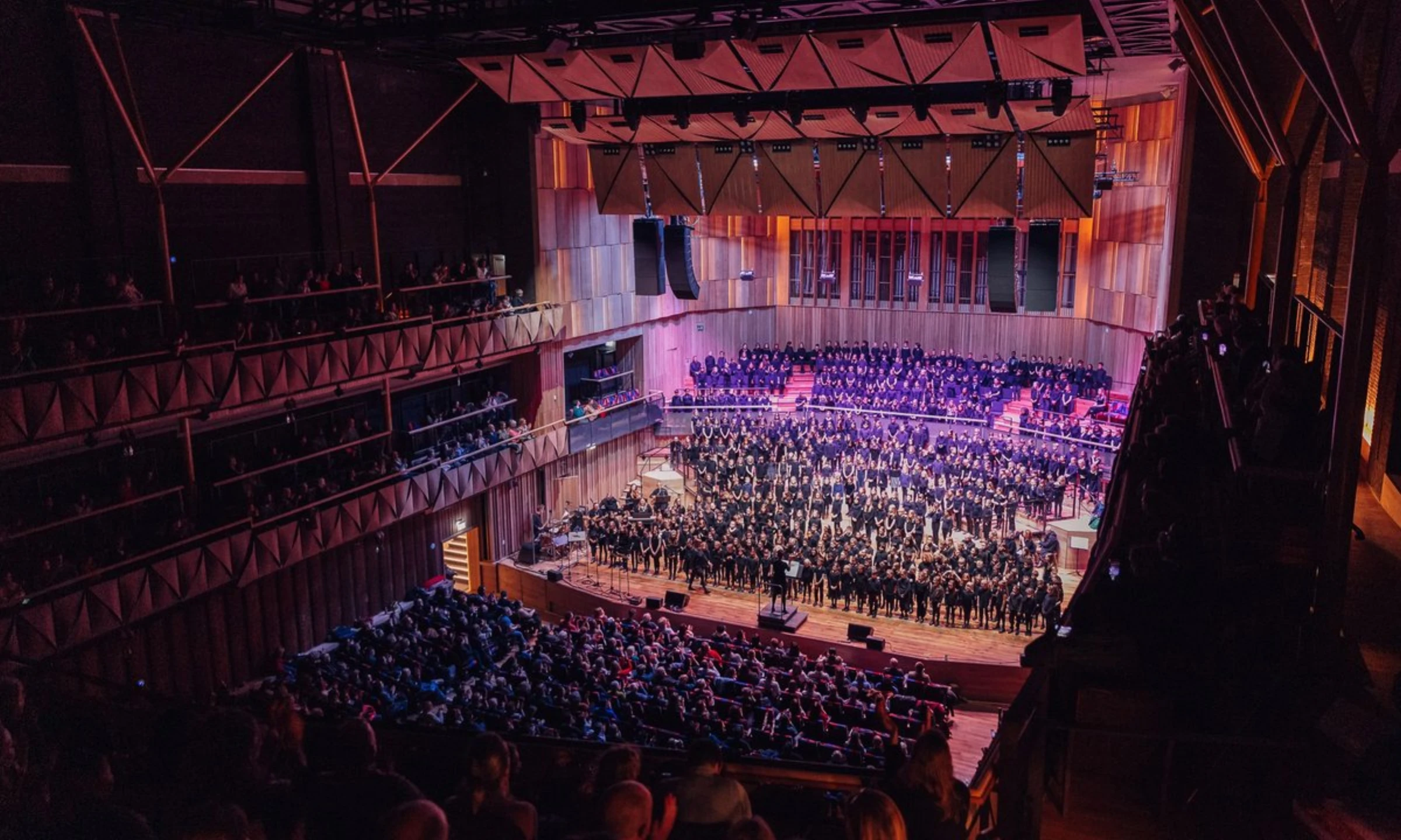 Schoolchildren singing in a Bristol school hall in an Arts Council England promotional image