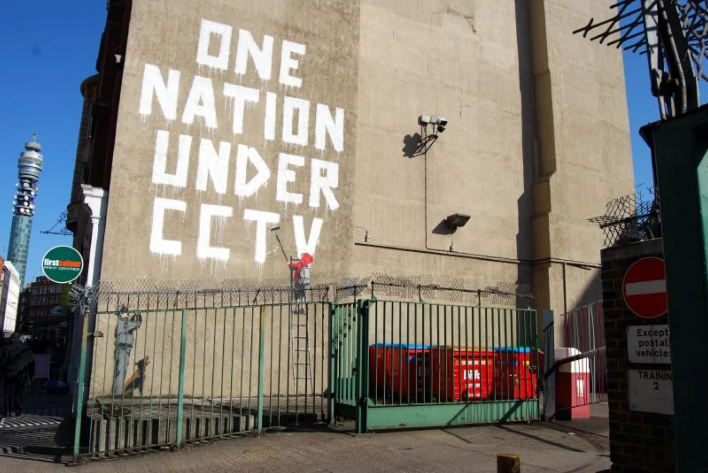 Banksy mural reading 'One nation under CCTV' on a London wall.