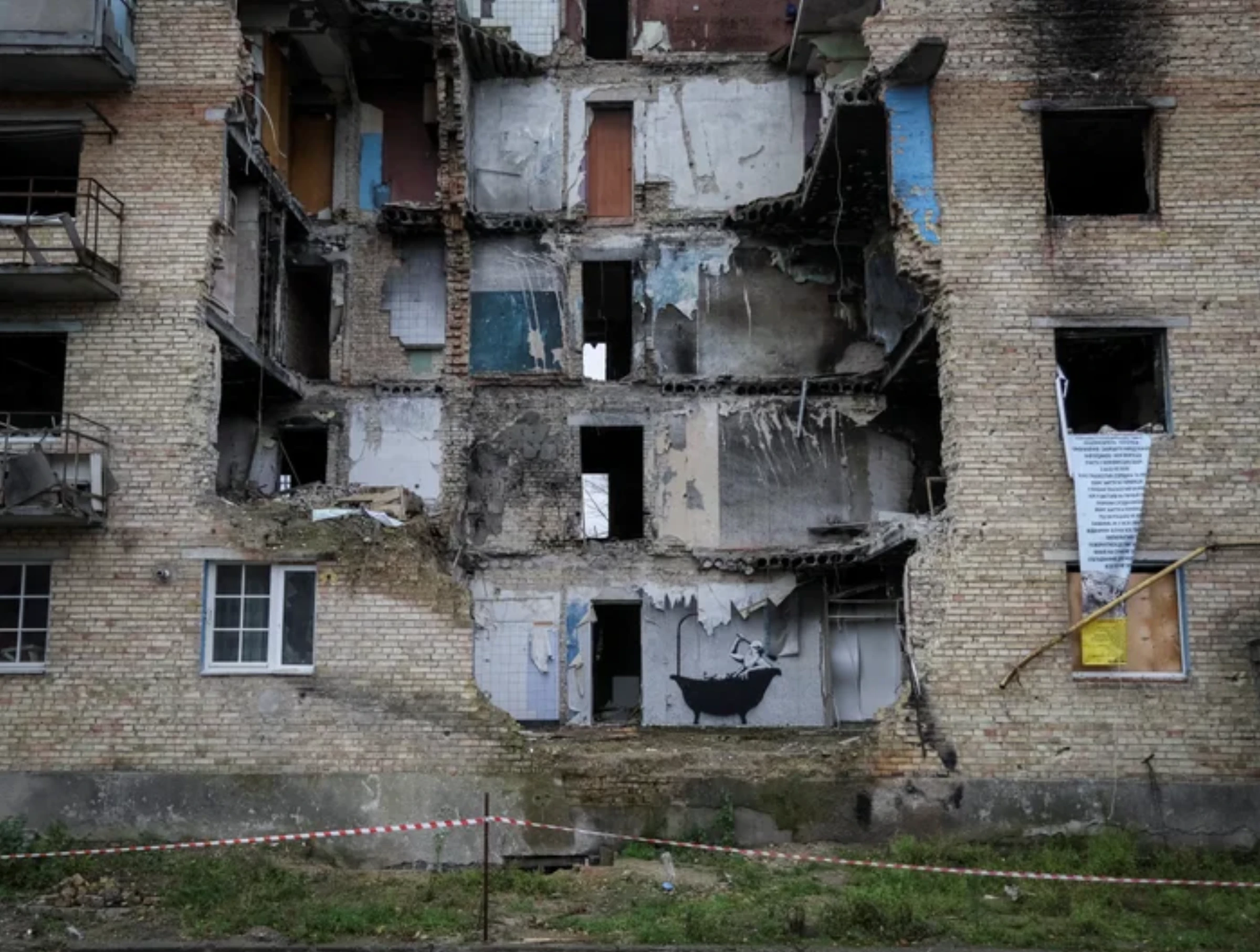 A Banksy mural on a war-damaged building in Ukraine.