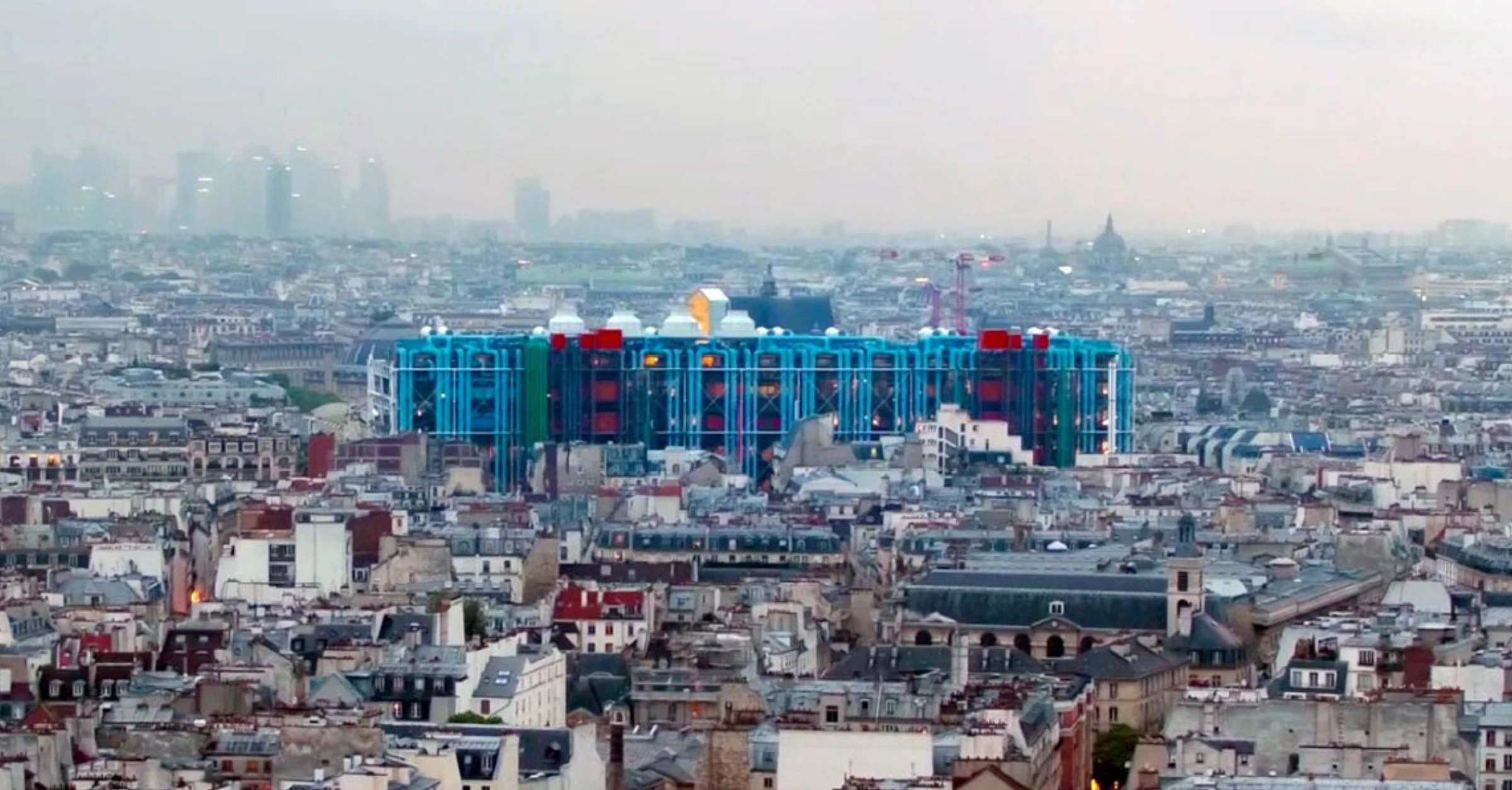 Exterior view of Centre Pompidou with its facade and exposed escalators in Paris