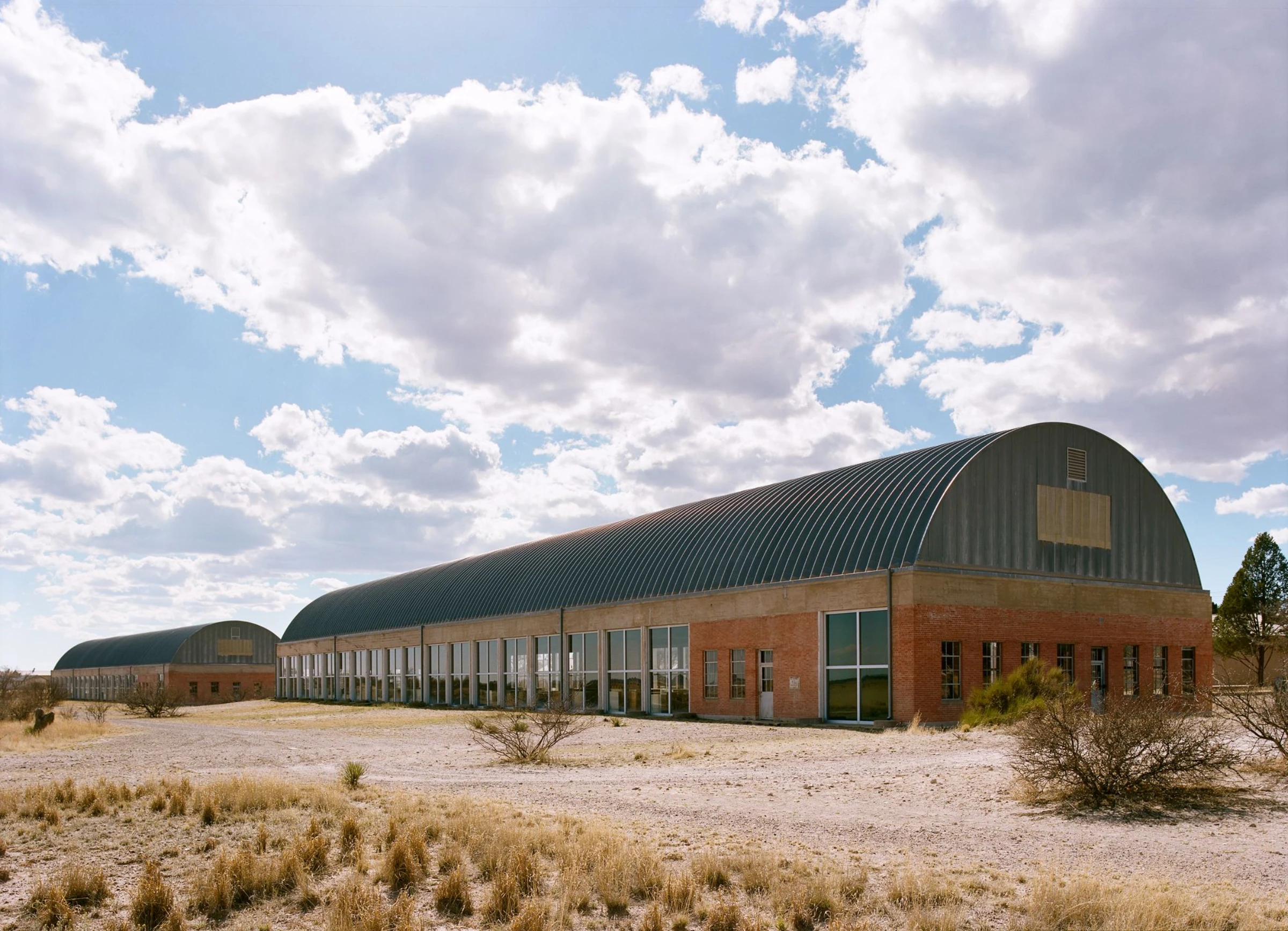 Donald Judd's Artillery Sheds at the Chinati Foundation in Marfa, Texas, showing the vaulted galvanized iron roofs and quartered windows that Judd installed to house his 100 untitled works in mill aluminum