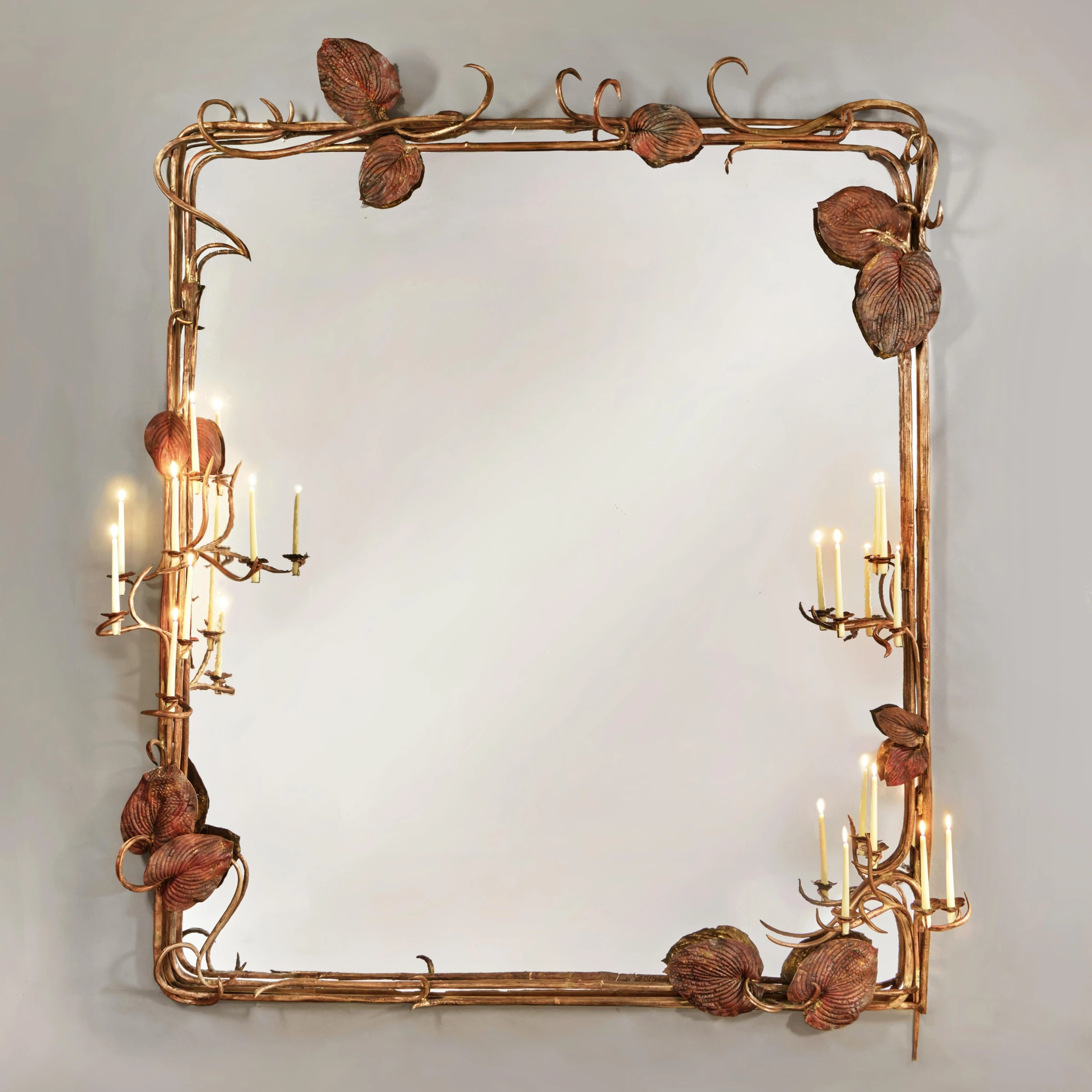 Claude Lalanne botanical mirror with textured bronze foliage and reflective center.