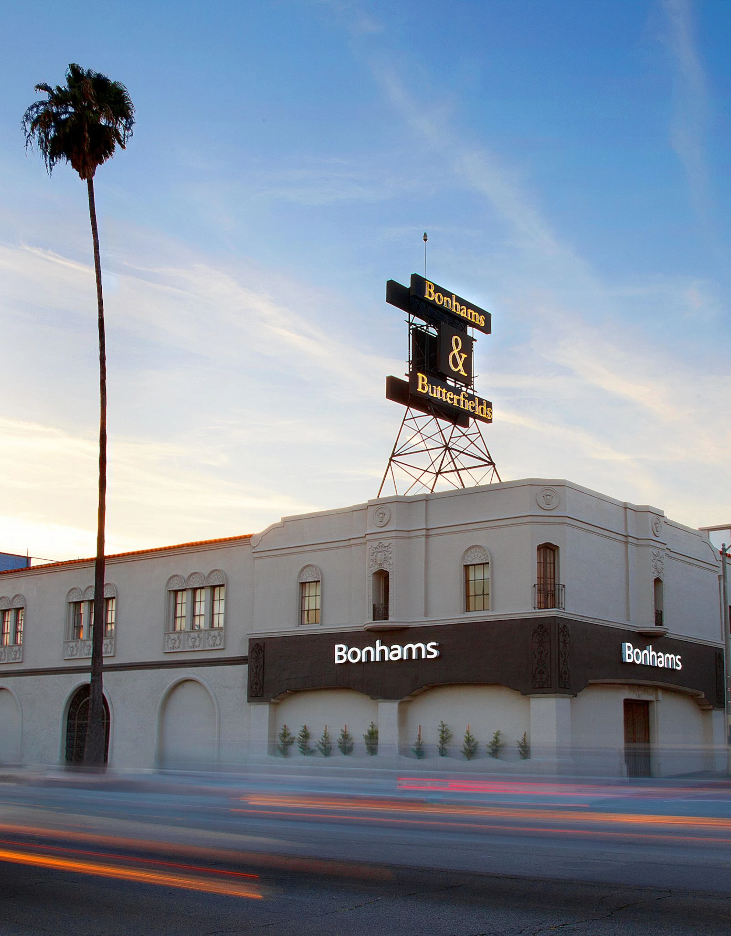Auction room interior with bidders and a work on offer.