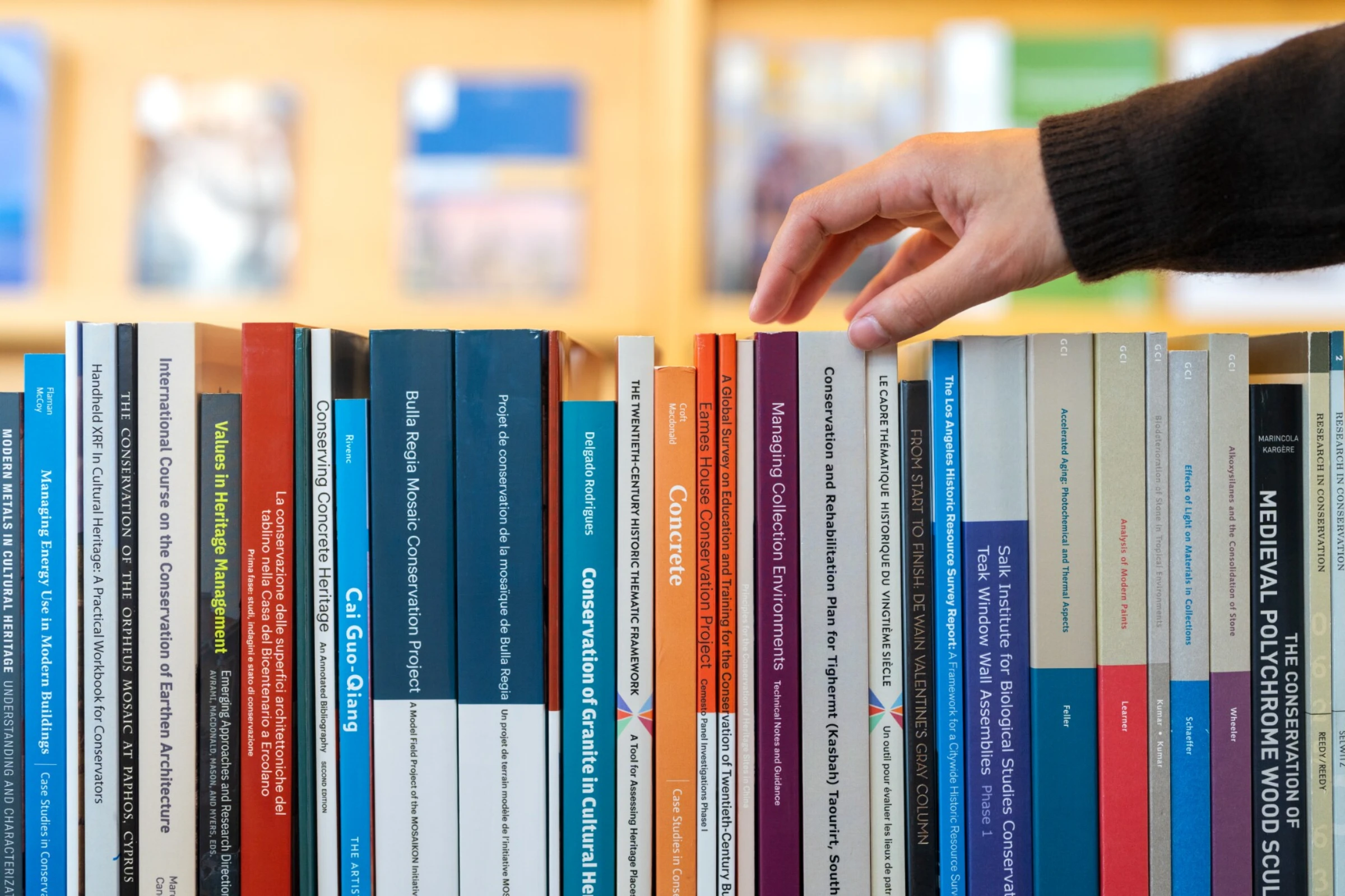Conservation professional examining an artwork in a controlled studio environment.