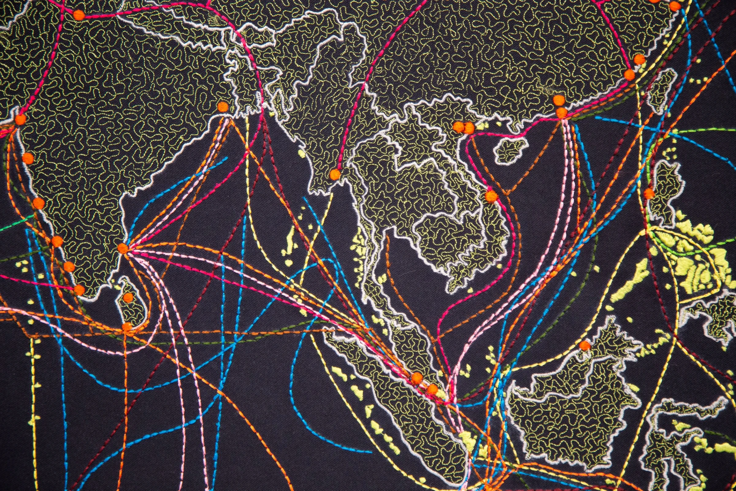 Crowded fair environment with collectors and galleries in active discussion.
