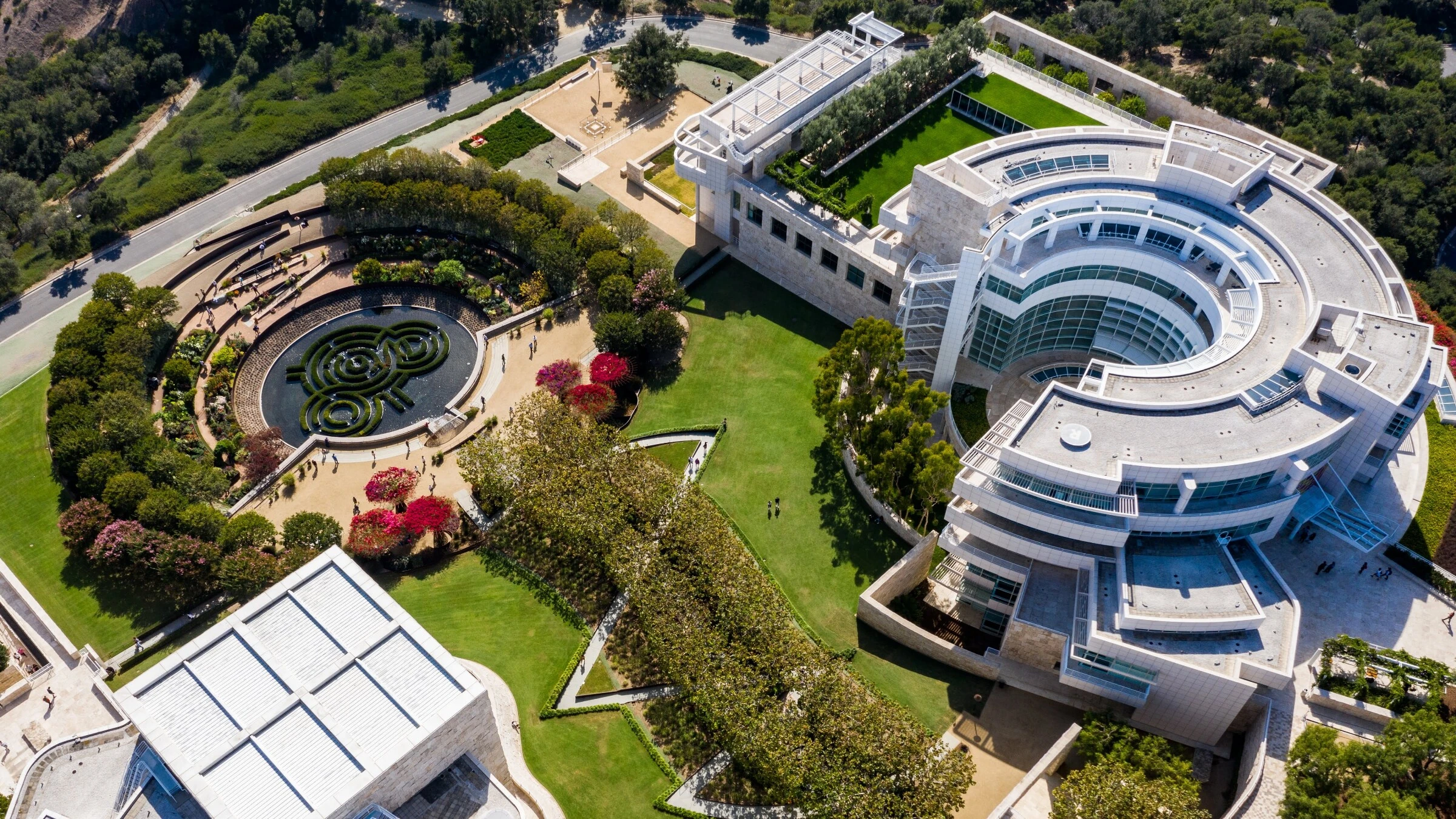 Visitors moving through a museum courtyard and gallery complex.