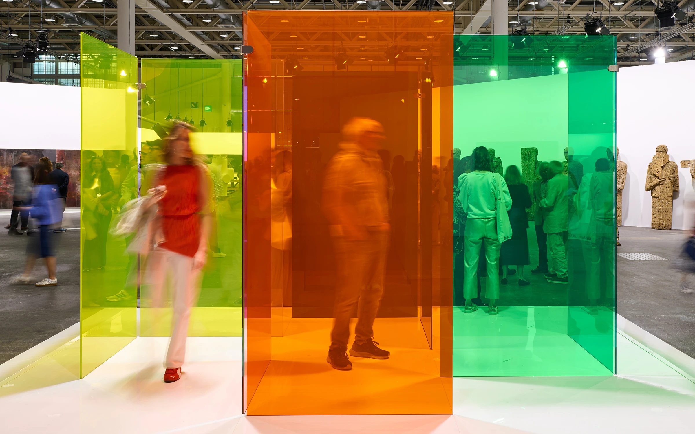Collectors reviewing artworks in a major international fair booth during VIP preview.