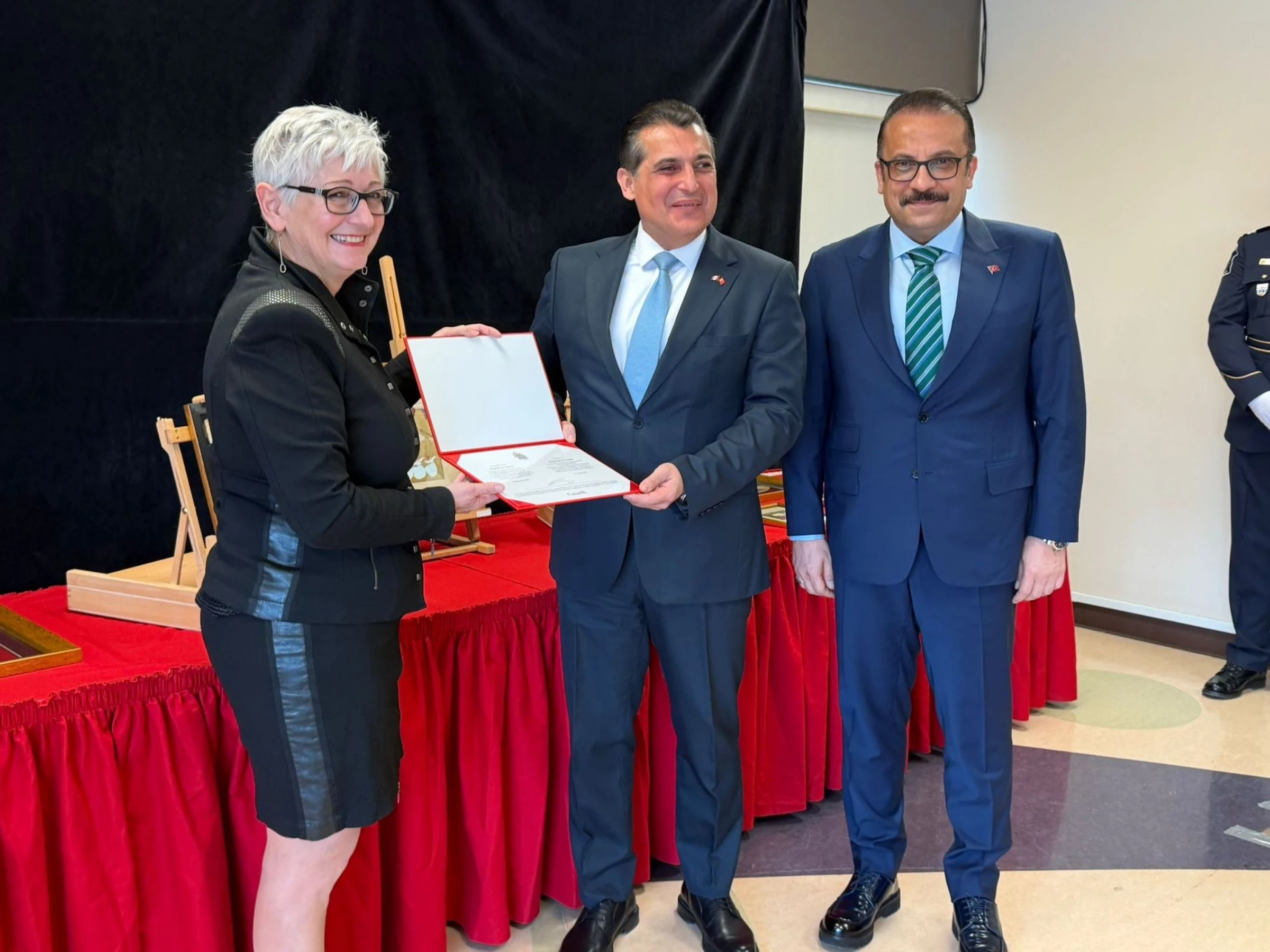 Interior gallery scene with visitors moving through a museum exhibition space.