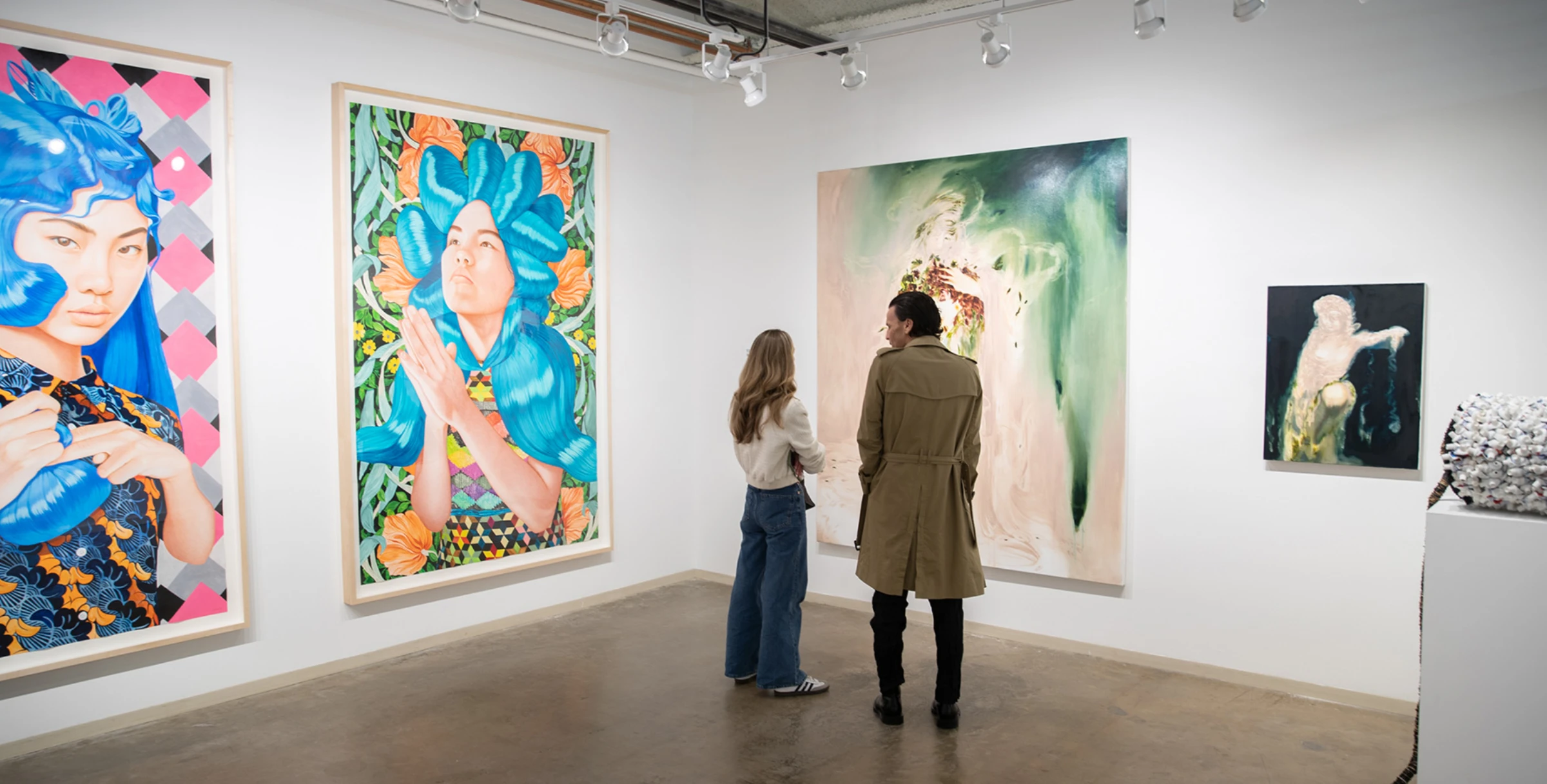 Visitors walking between booths during the Dallas Art Fair, with artworks visible across stands
