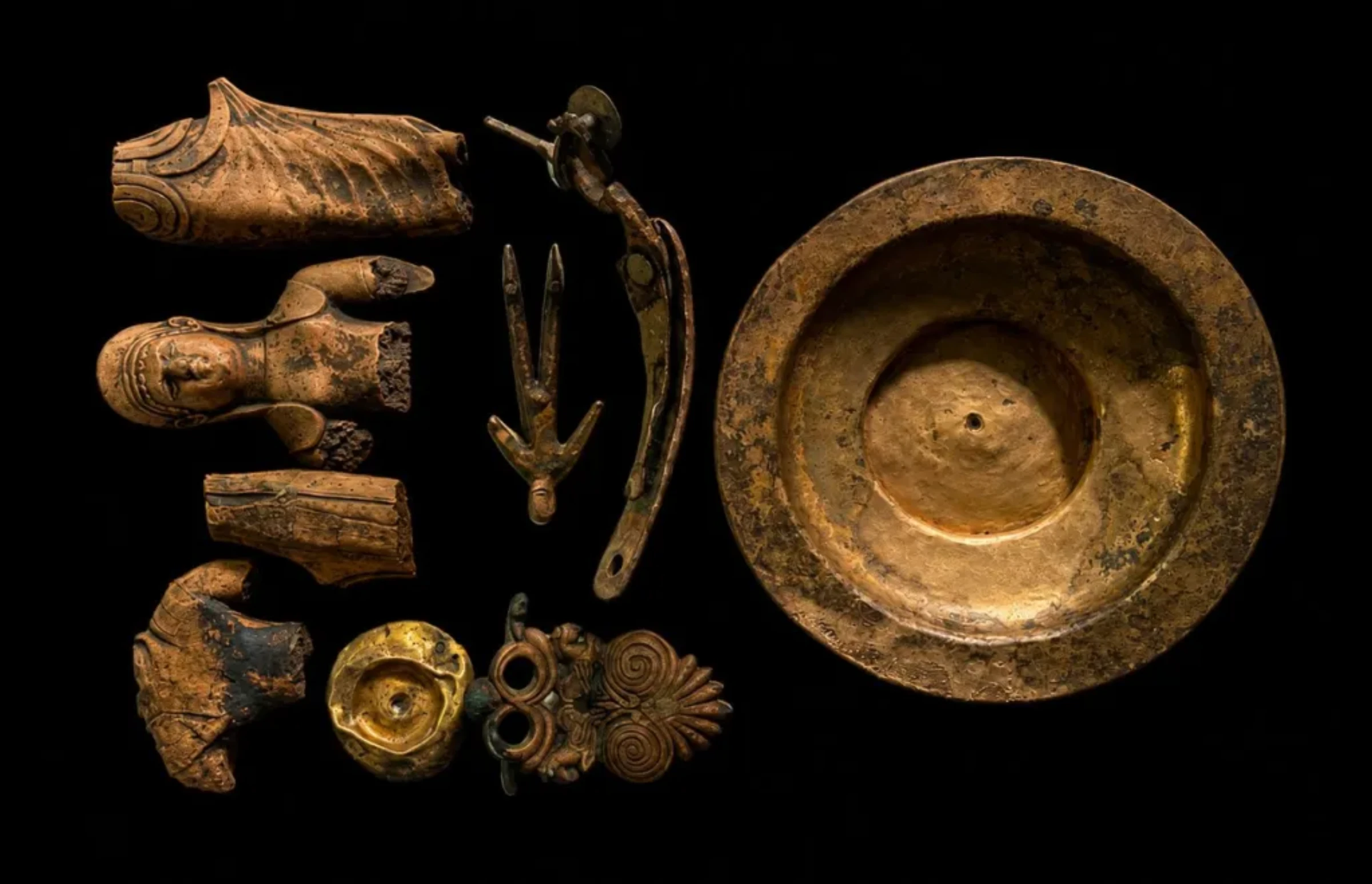 Bronze Etruscan artifacts recovered from an ancient well near Marzabotto, Italy, including female figurines and a bronze bowl with visible metallic luster after 2,500 years