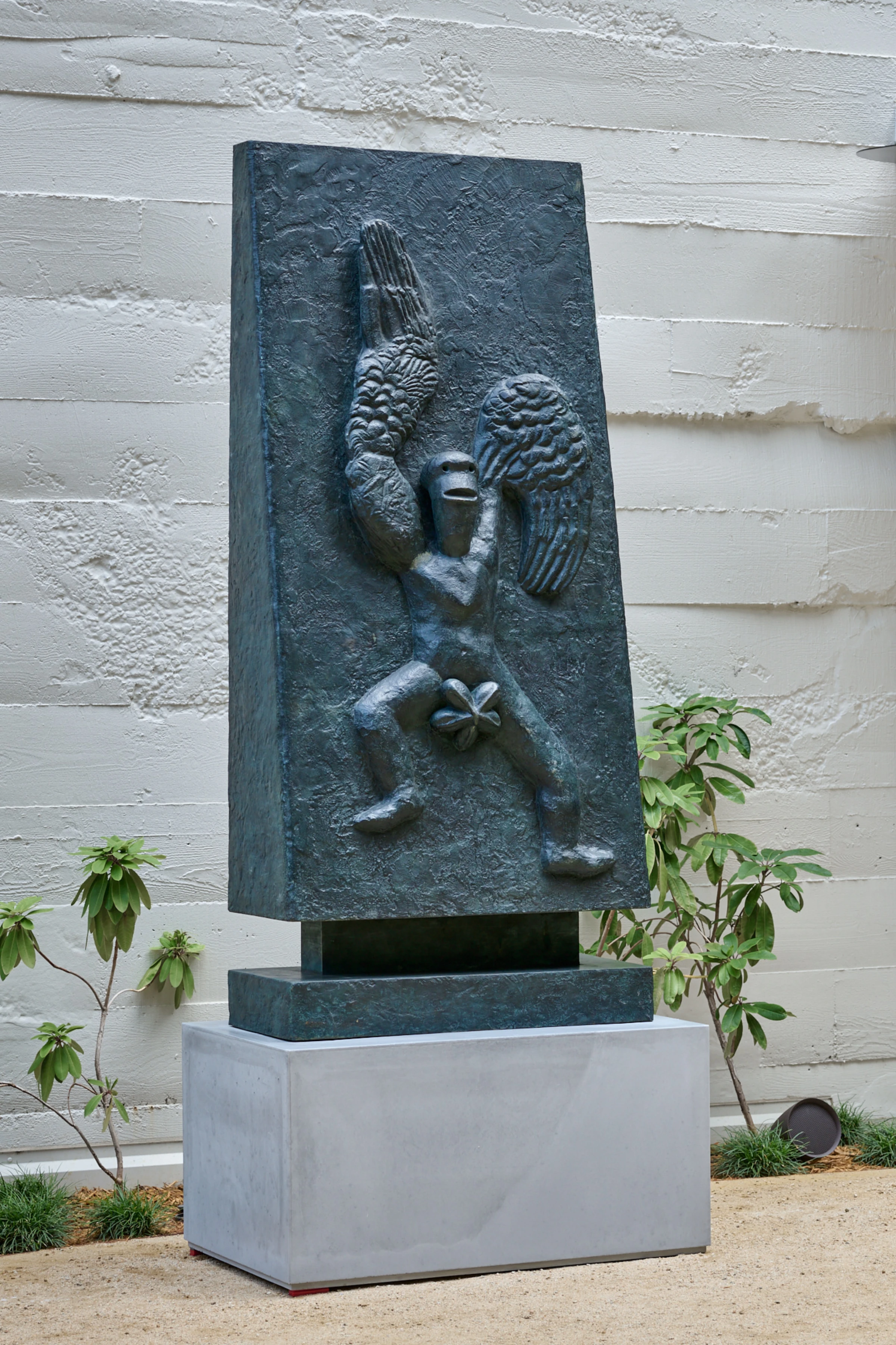 An installation view with large-scale contemporary artworks and visitors at a fair setting.