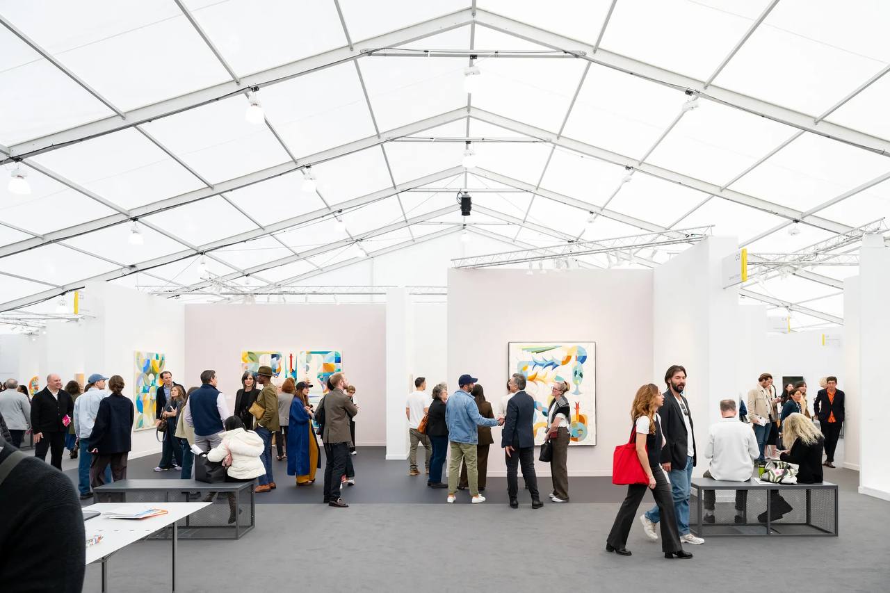Collectors and visitors viewing booths at a contemporary art fair