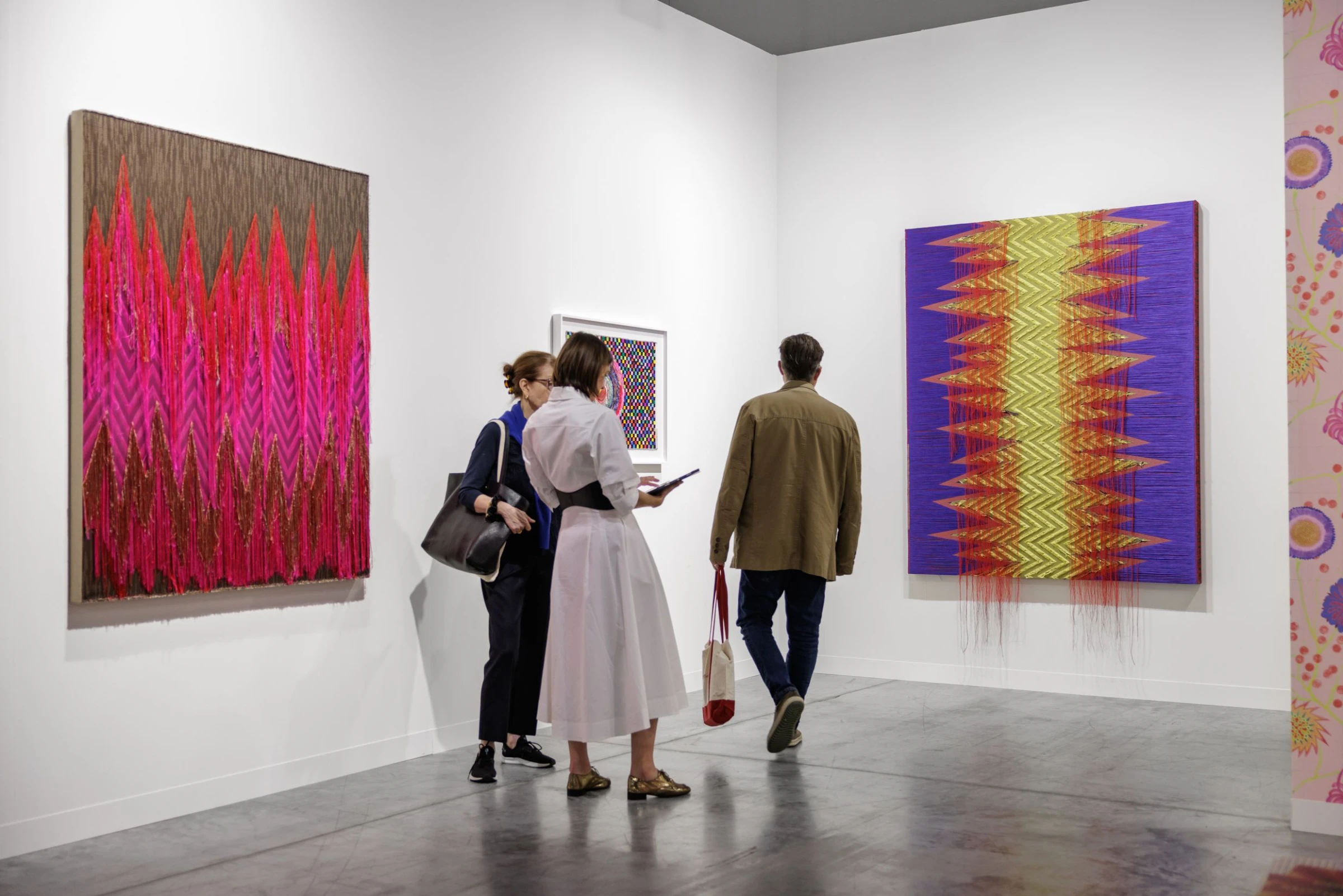 Visitors at an international art fair preview looking at blue-chip contemporary works.