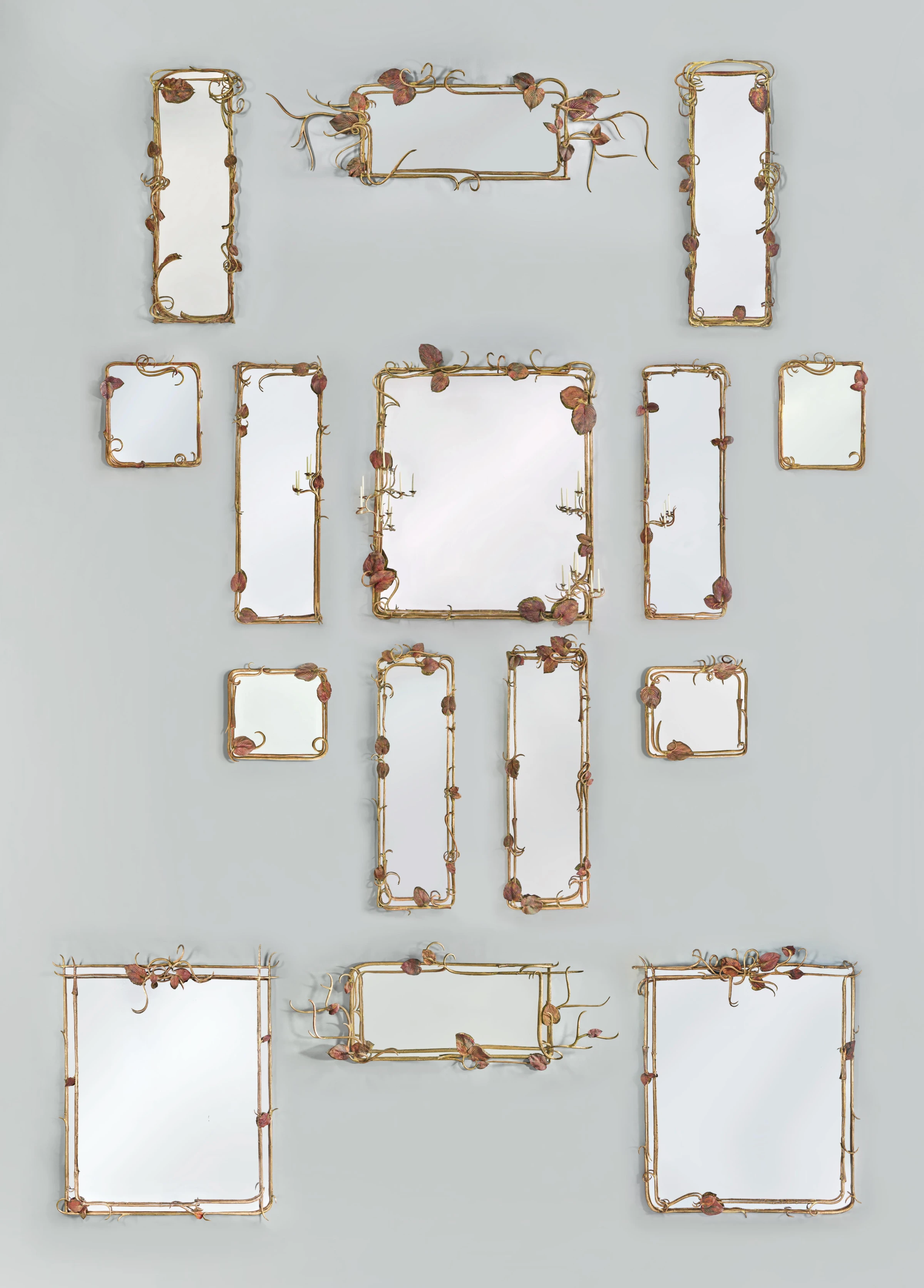 Grouped display of collectible design mirrors in a pre-sale auction installation.