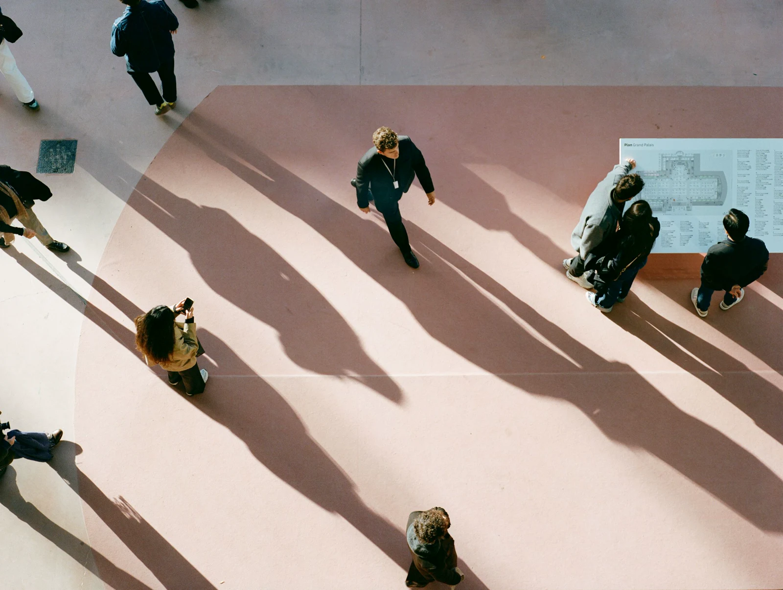 View across Art Basel Paris with visitors moving through the fair floor beneath the Grand Palais architecture