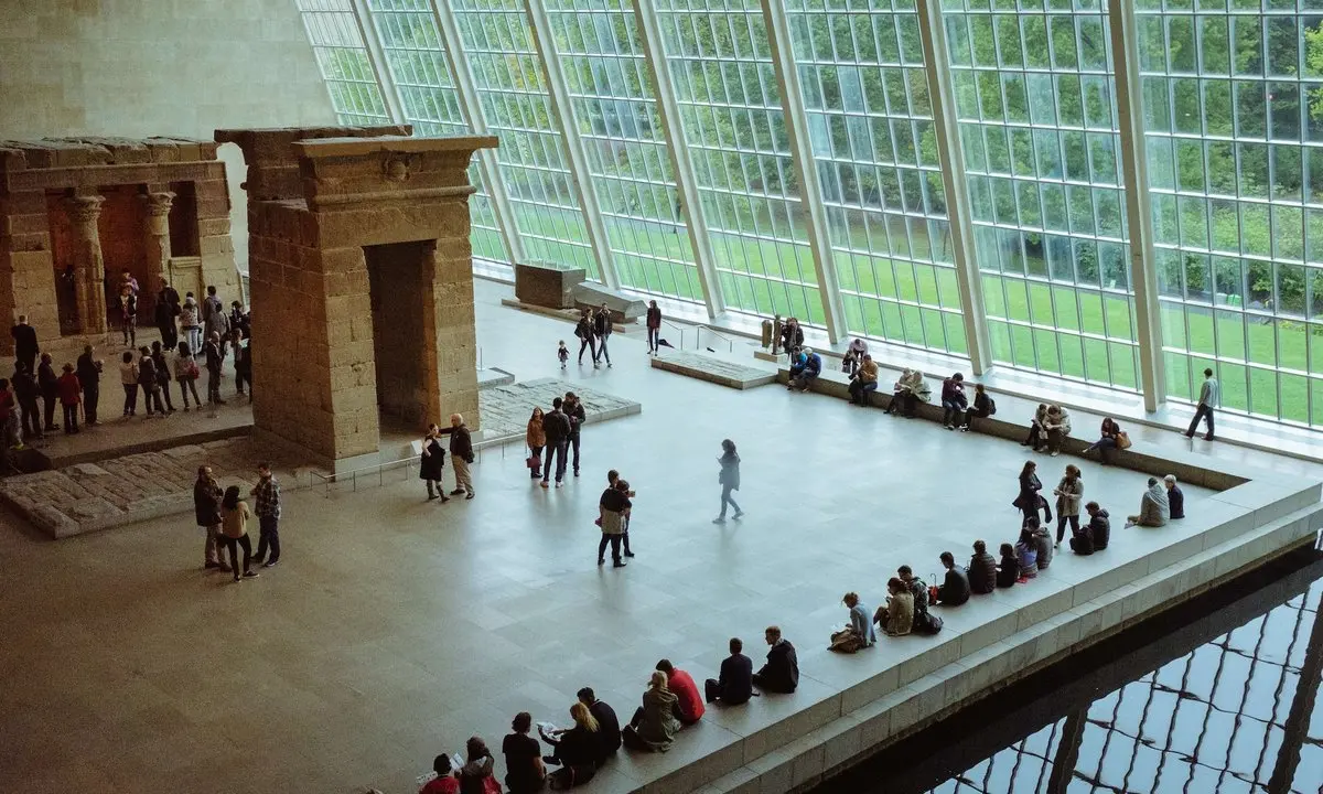 Visitors on the steps outside a major art museum used to illustrate museum admission policy debates
