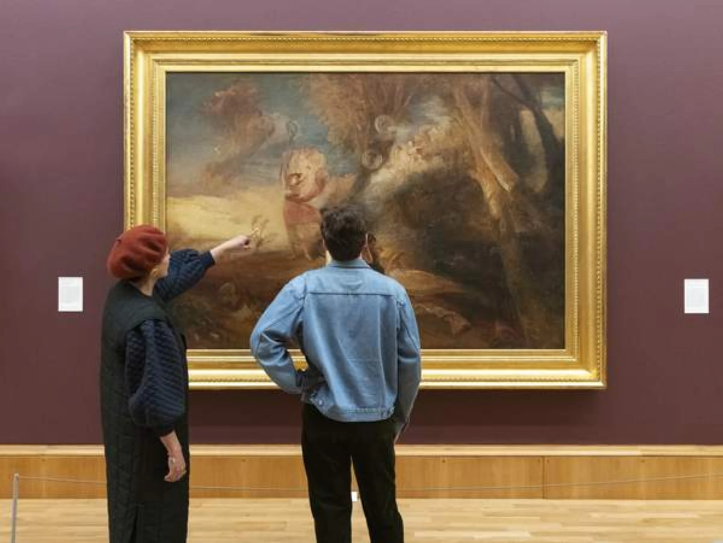 Visitors inside Tate Britain viewing a large gallery installation