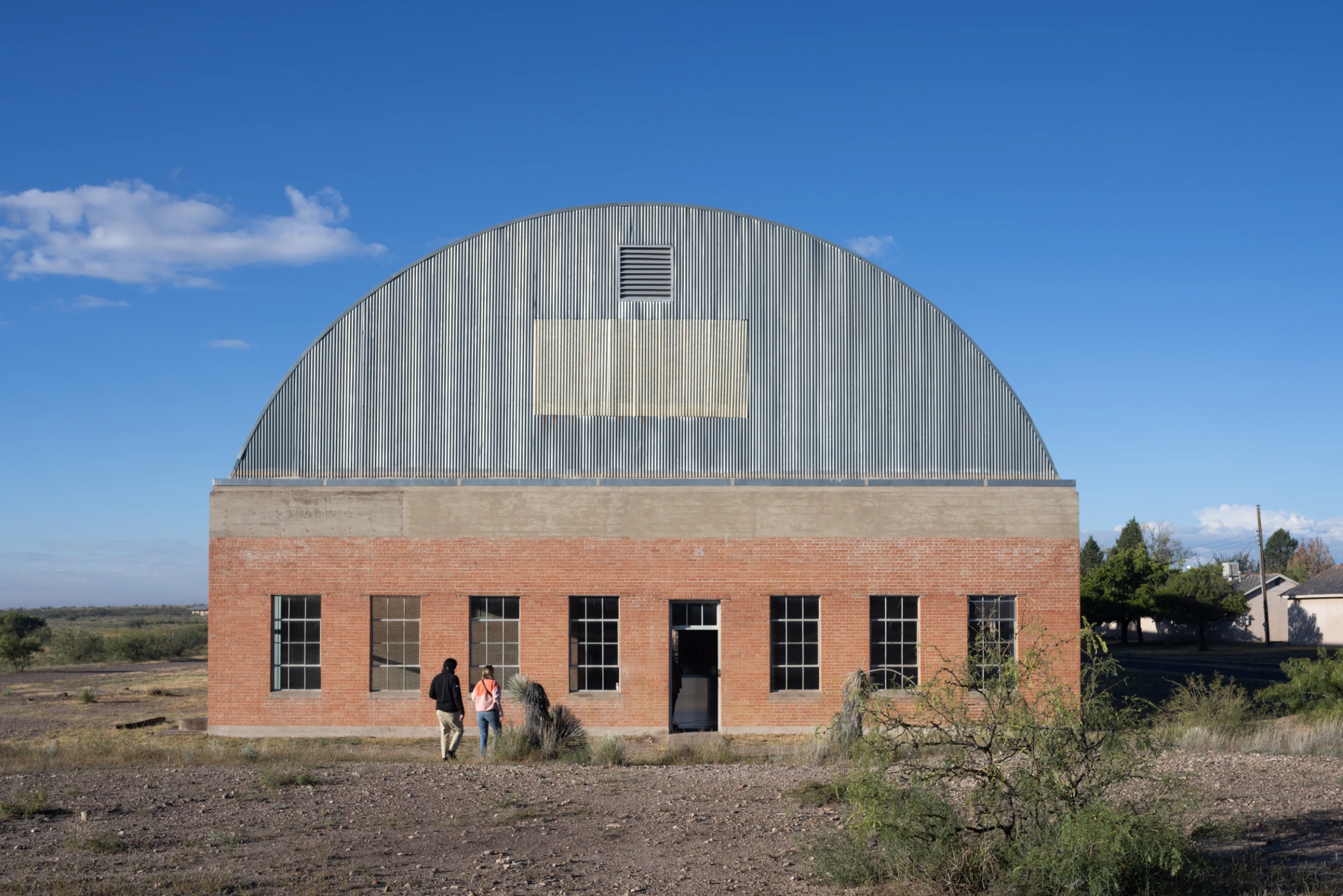 Sunrise viewing at the Chinati Foundation in Marfa, Texas, showing Donald Judd's untitled concrete works arranged across the desert landscape