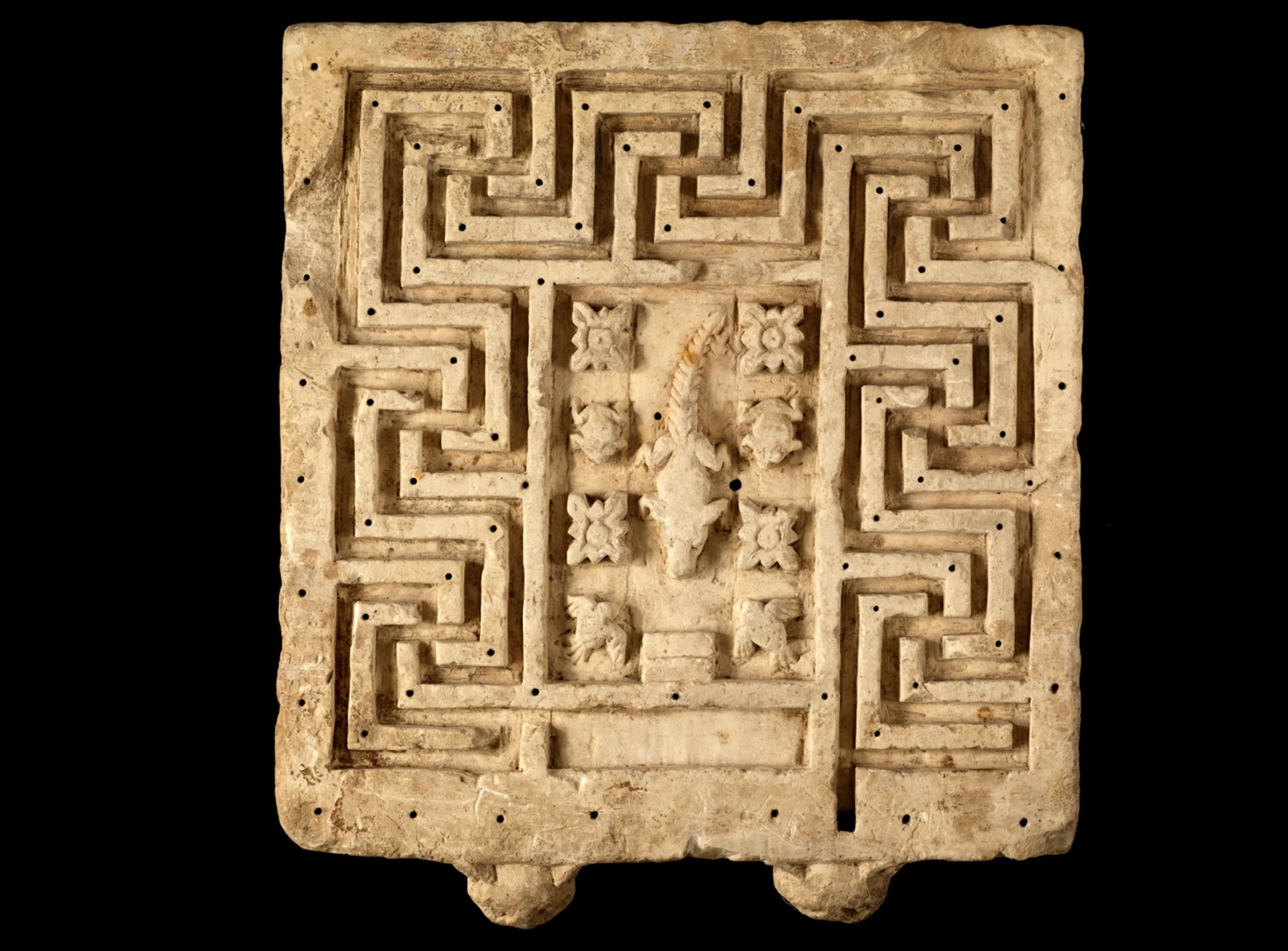 Gallery interior at the Louvre with historic painted works on the walls.