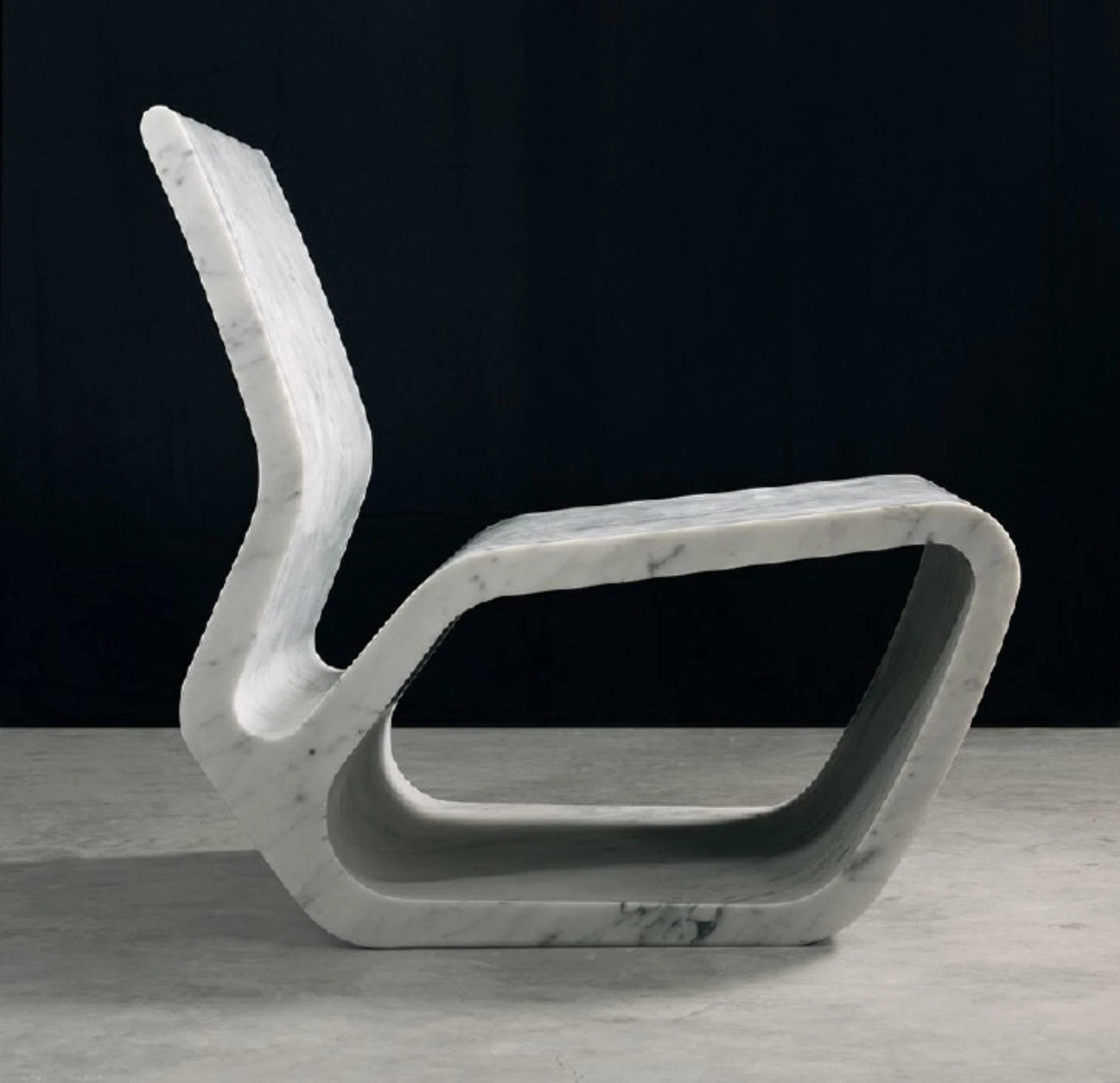 A sculptural design object by Marc Newson shown in polished metallic finish.