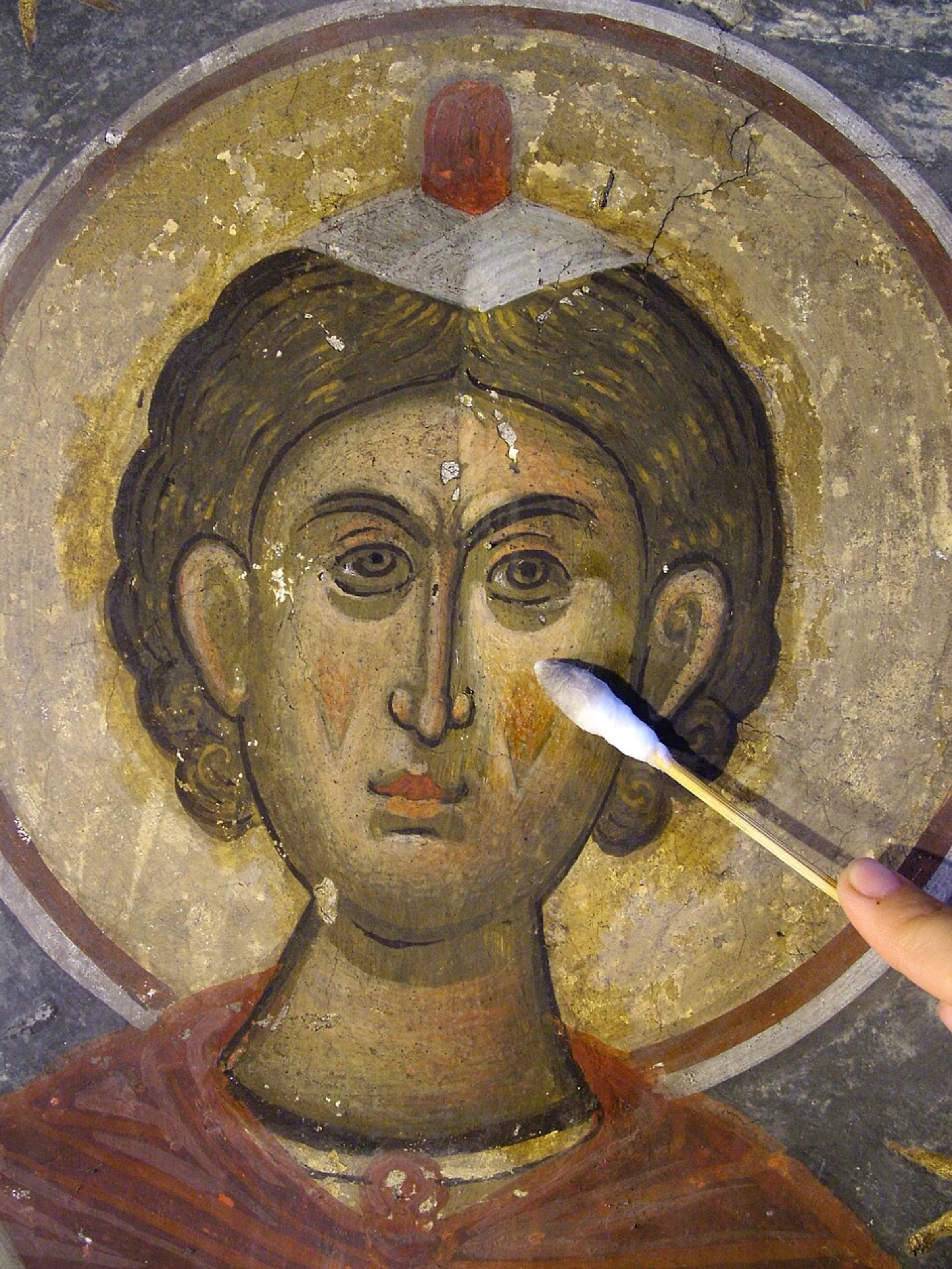 Conservation work being performed on the exterior of a historic painted church in Sucevita, Romania