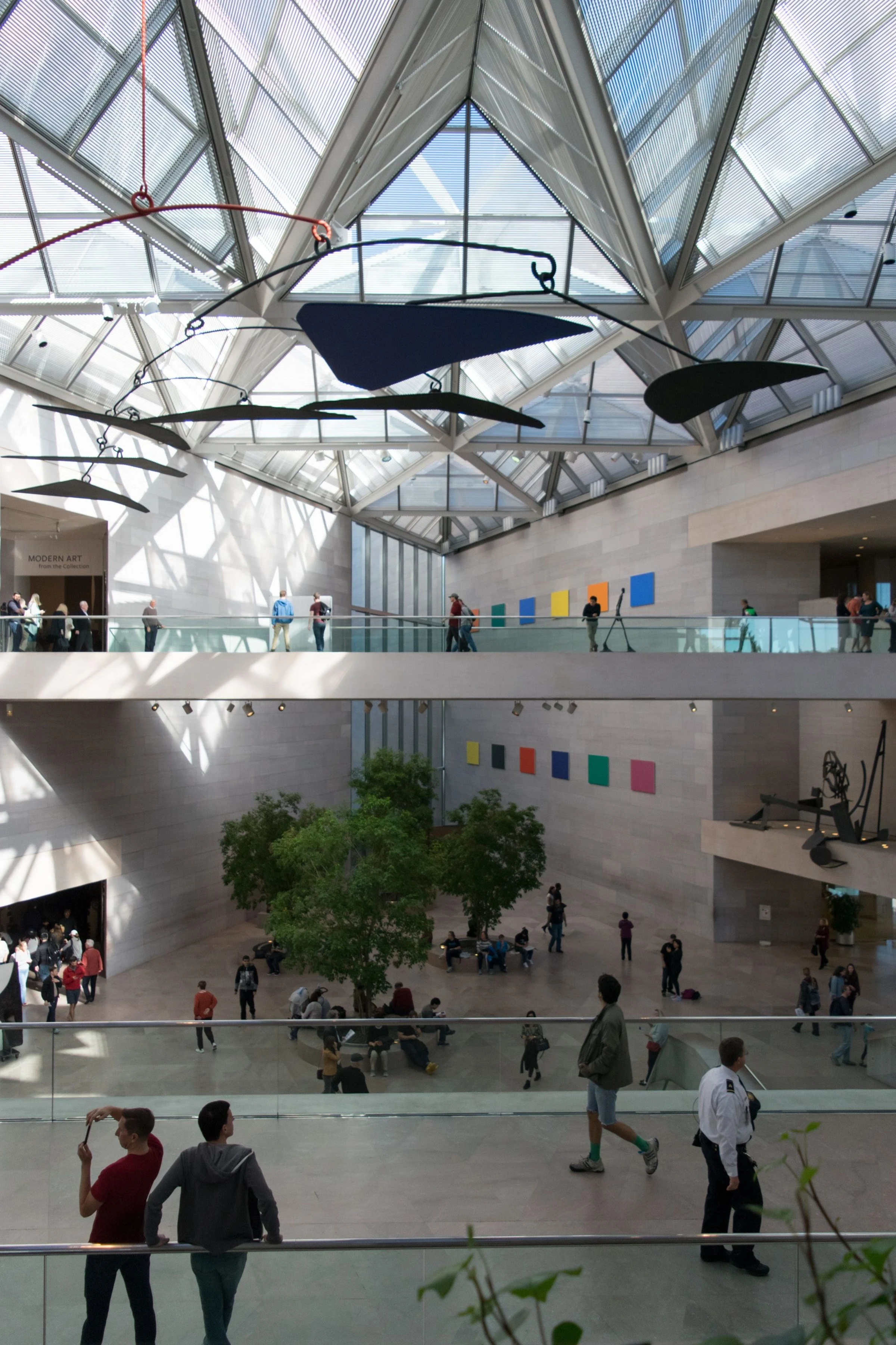 Museum visitors viewing paintings in a gallery, illustrating long-term lending and shared collection access.