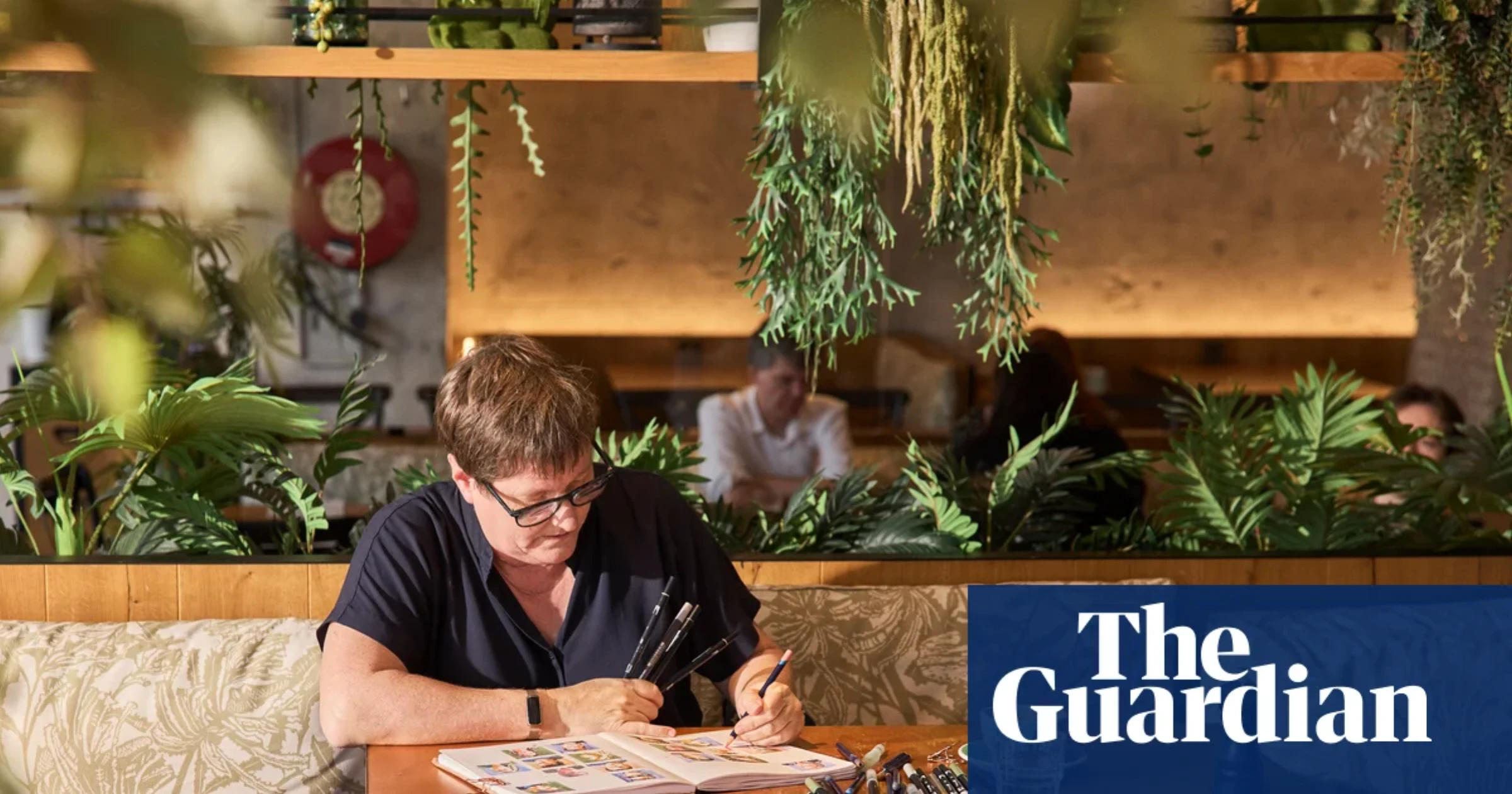 Liz Steel sketching people in a cafe during the #OneWeek100People challenge