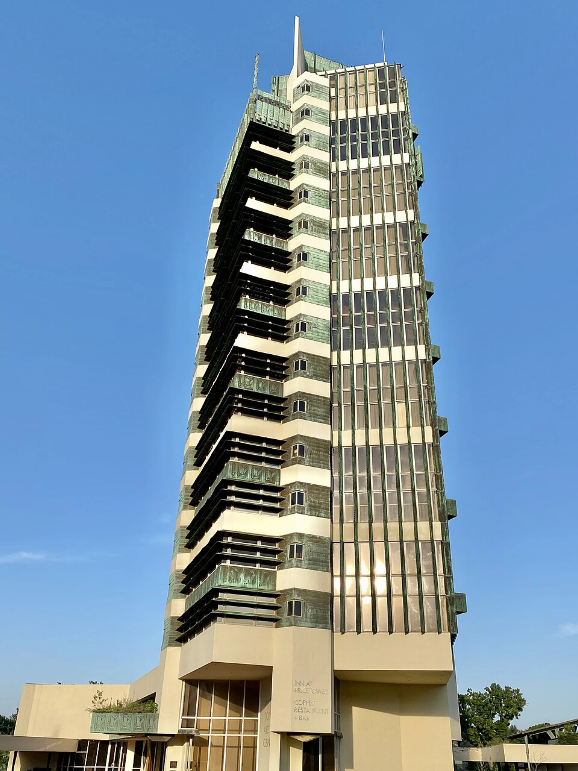 Price Tower in Bartlesville, Oklahoma, Frank Lloyd Wright's only skyscraper, completed in 1956, a nineteen-story copper and concrete building visible against the sky