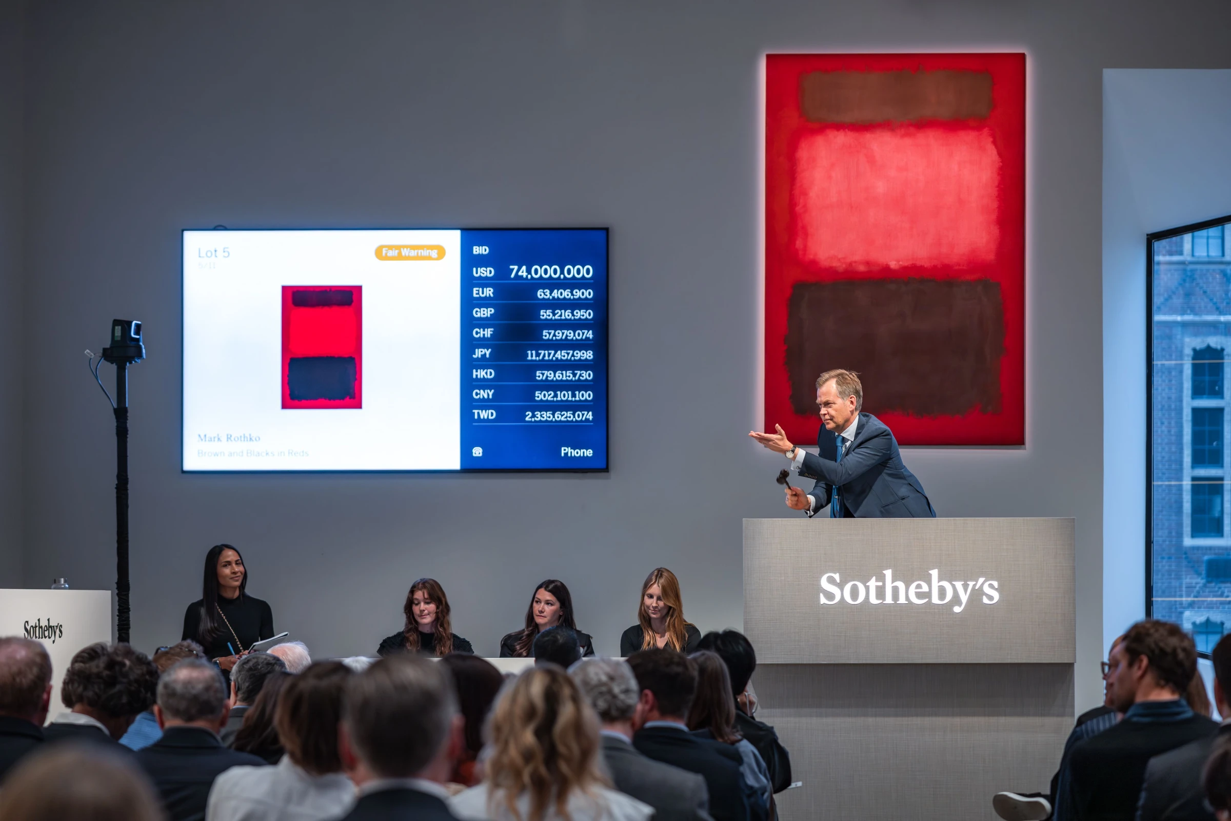 Auctioneer Oliver Barker selling Mark Rothko's Brown and Blacks in Reds during Sotheby's New York evening sale