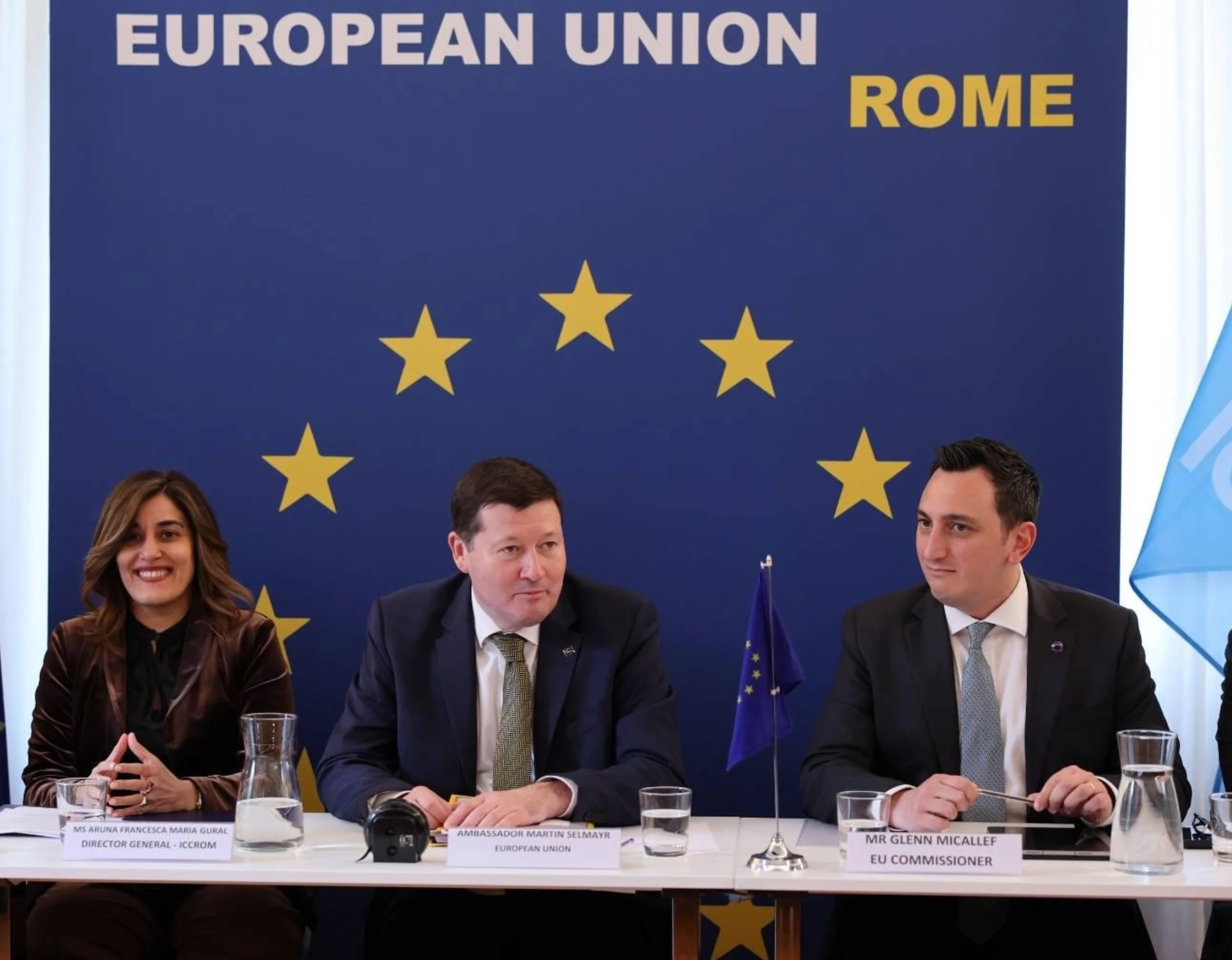 Cultural heritage professionals examining historic wall paintings in a conservation setting.