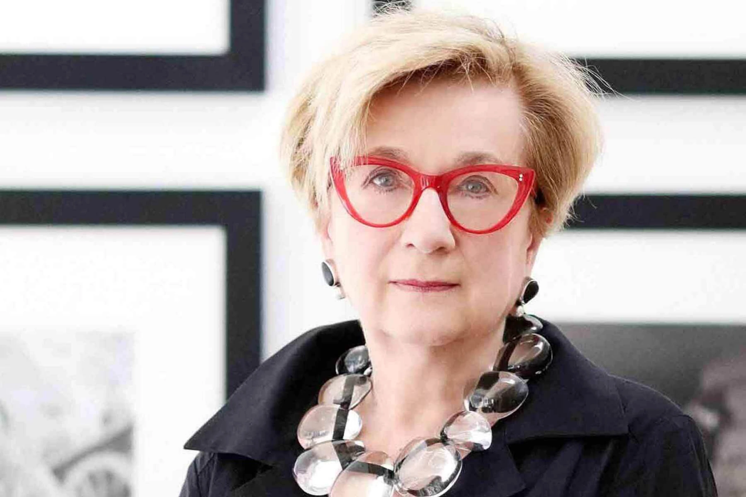 Portrait of Lynda Roscoe Hartigan in a dark blazer against a neutral background.