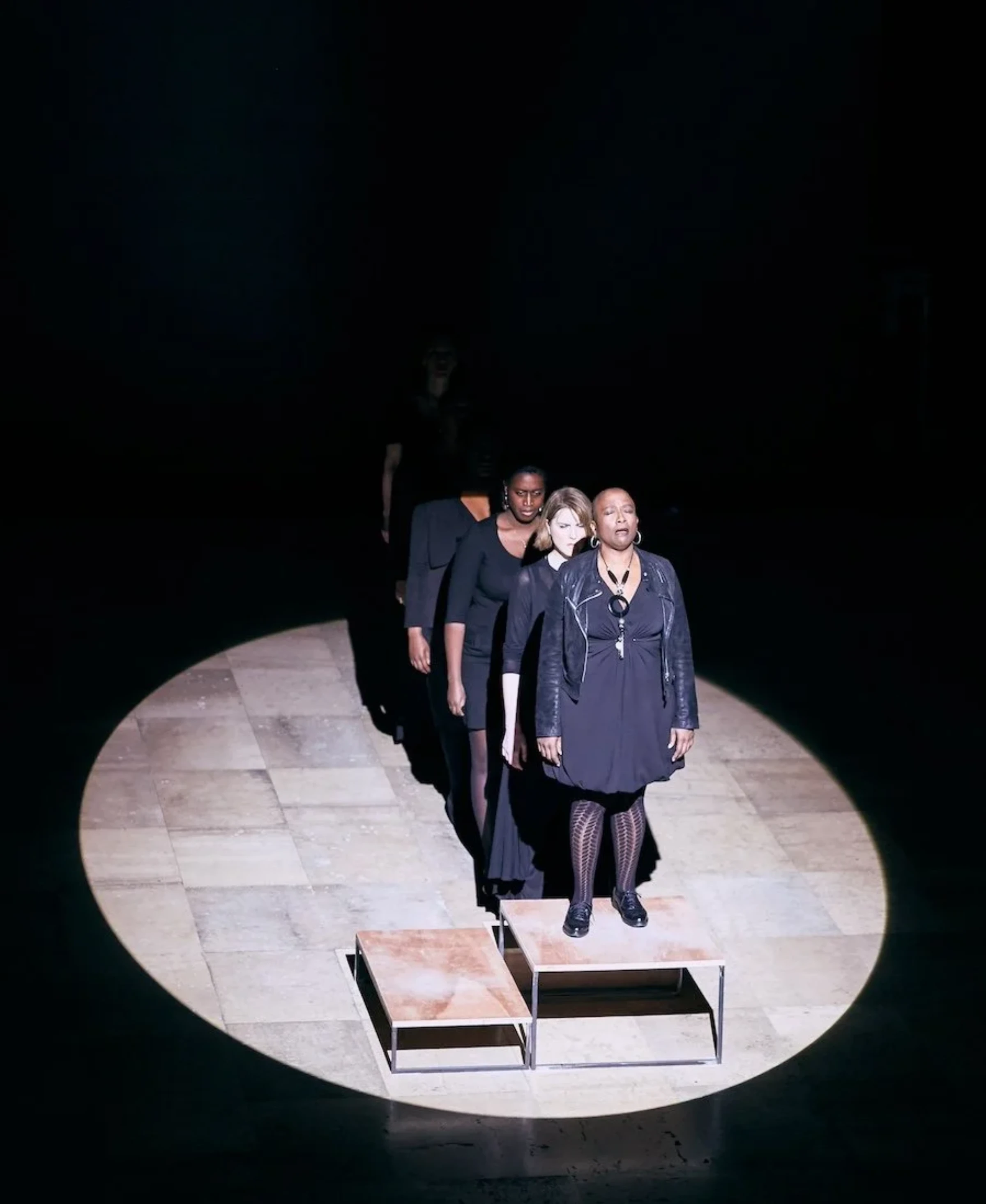 A still from Gabrielle Goliath’s Elegy showing a vocalist in low light during the mourning performance.