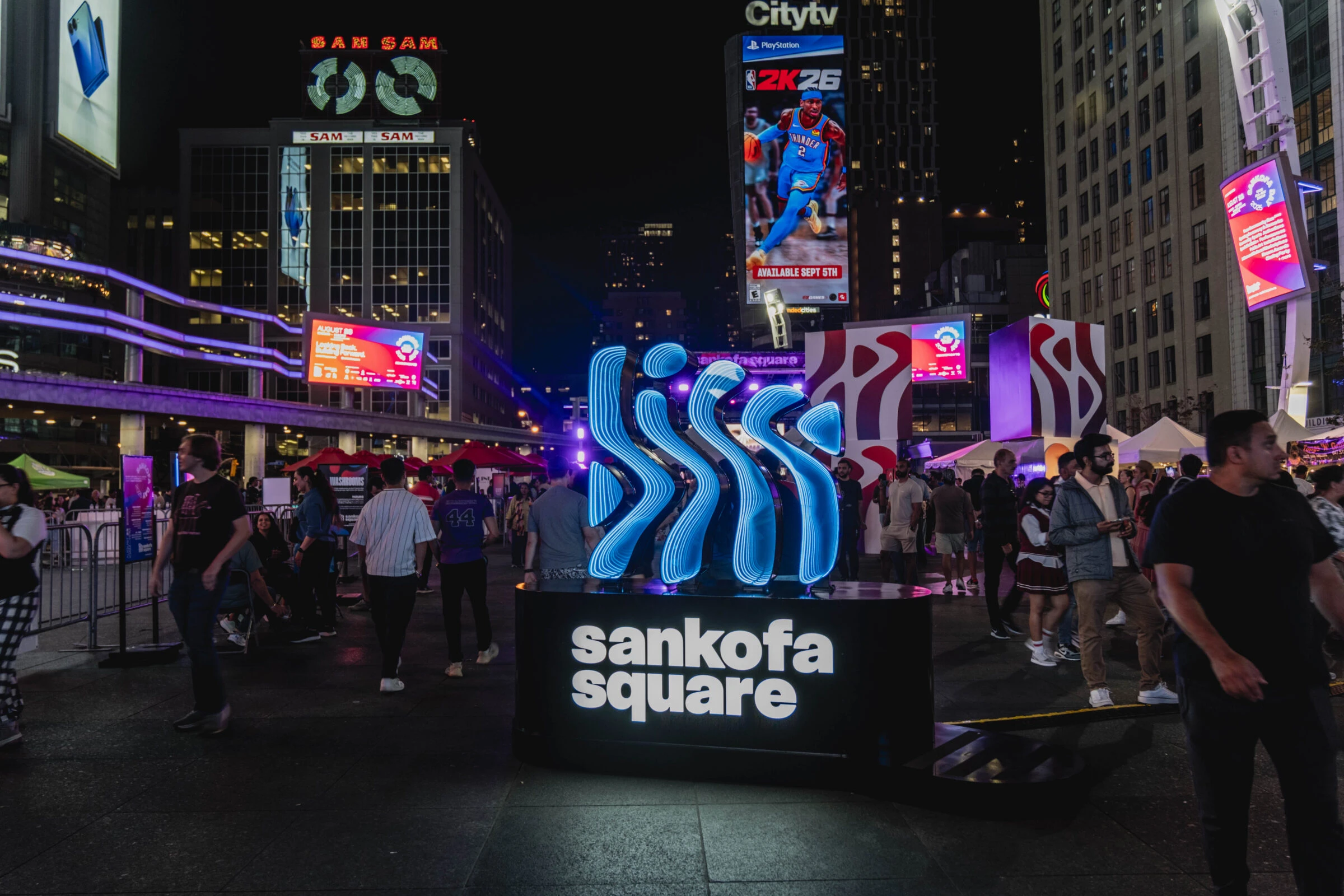 Audience gathered outdoors at a Toronto Biennial public program.