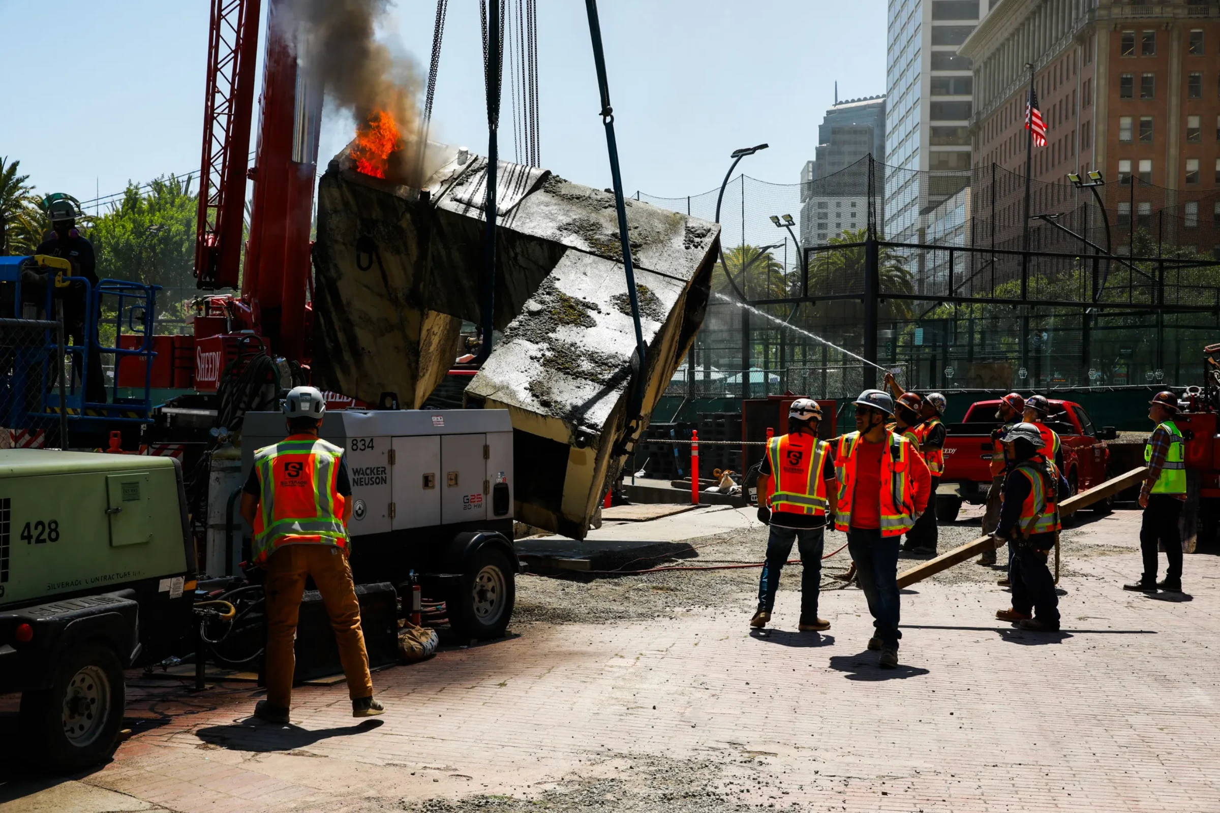 Smoke rising around the Vaillancourt Fountain during dismantling in San Francisco.
