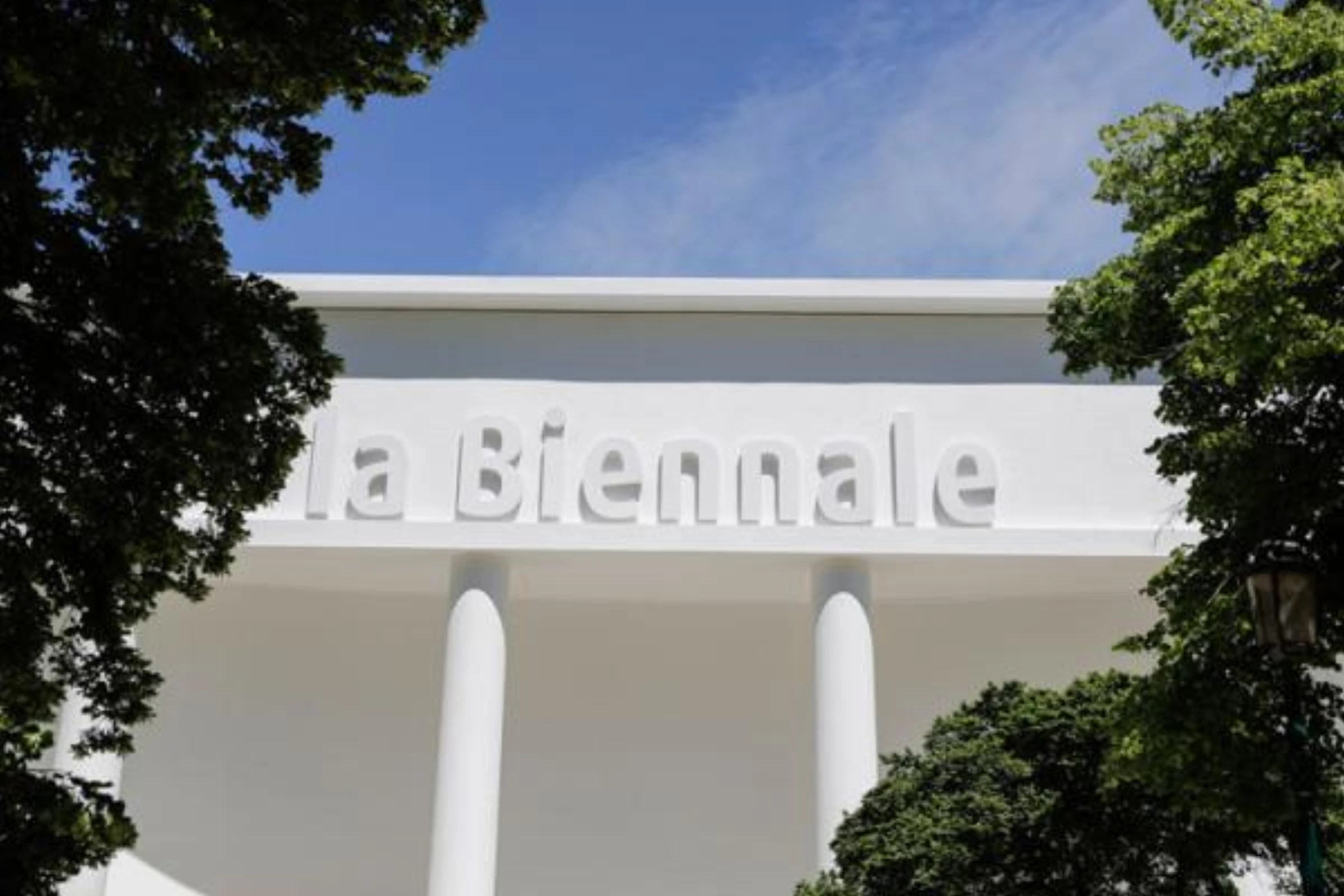 Interior view of the renovated Central Pavilion at the Giardini with white galleries and exposed trusses