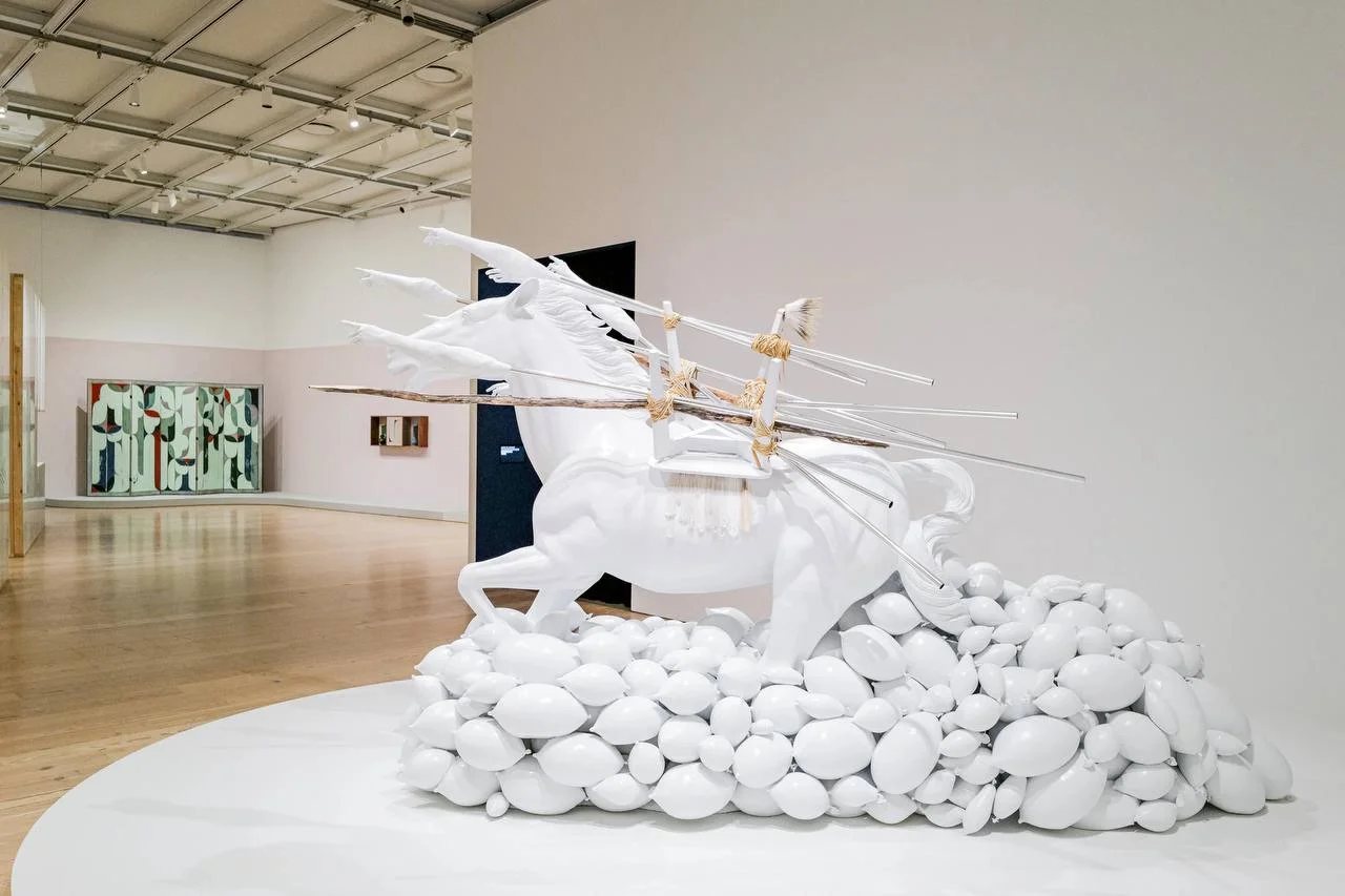 Installation view of the Whitney Biennial 2026 featuring a large white horse sculpture at the Whitney Museum of American Art